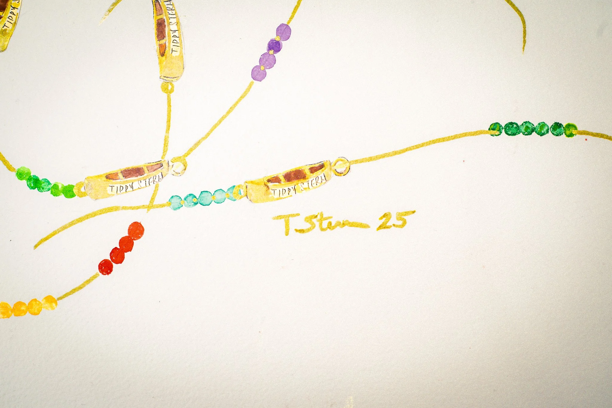 Colorful beaded necklaces with yellow canoes labeled "Tippy Stern"