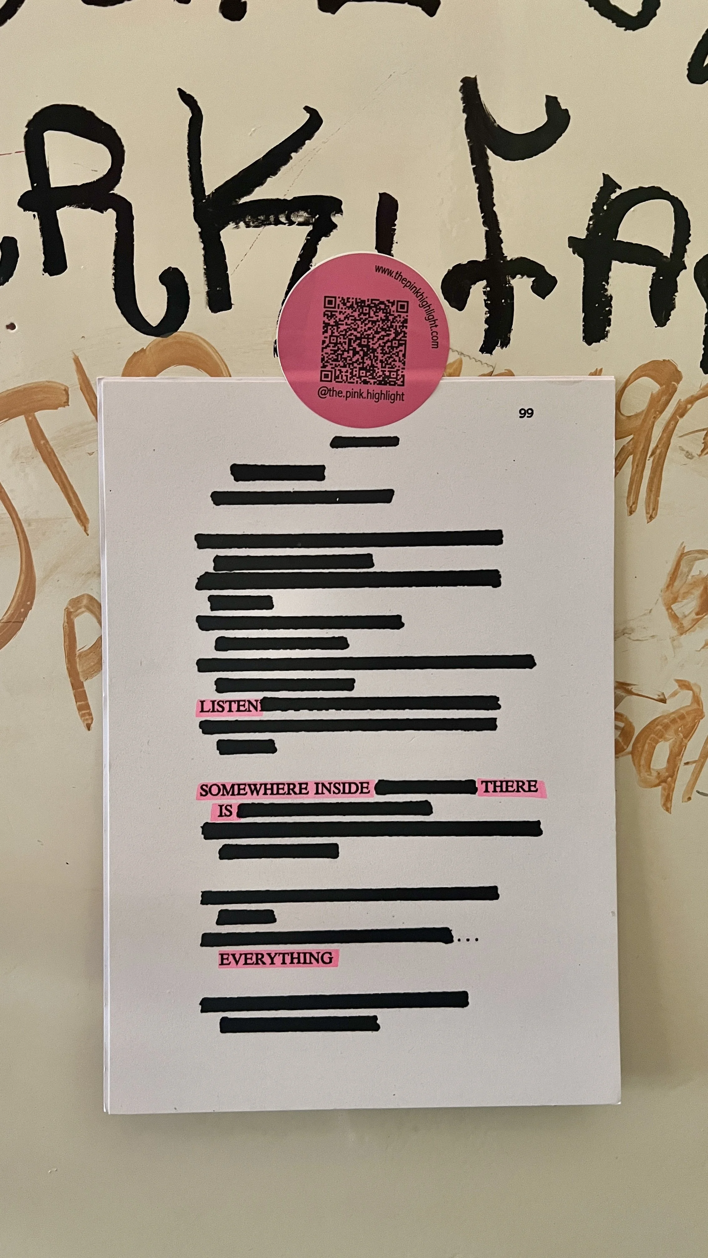 A page with blacked-out text and pink highlights that read 'LISTEN', 'SOMEWHERE INSIDE', 'THERE', and 'EVERYTHING'. A QR code is attached at the top of the page, with a website URL. The background features partially visible handwritten black text.