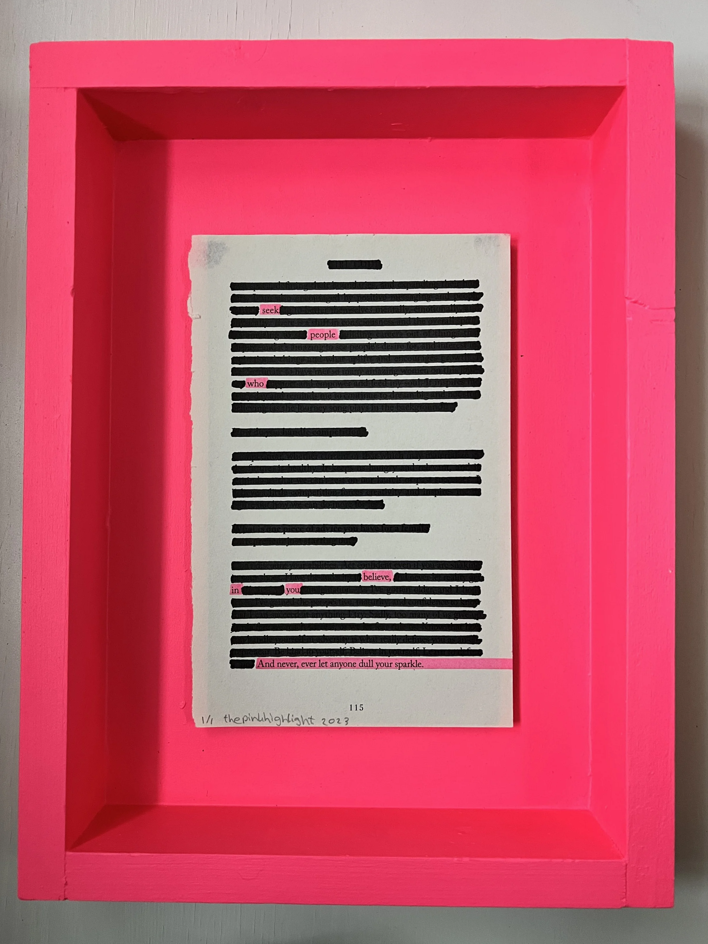 A pink box with a piece of paper containing text, some of which are highlighted in pink and blacked out.