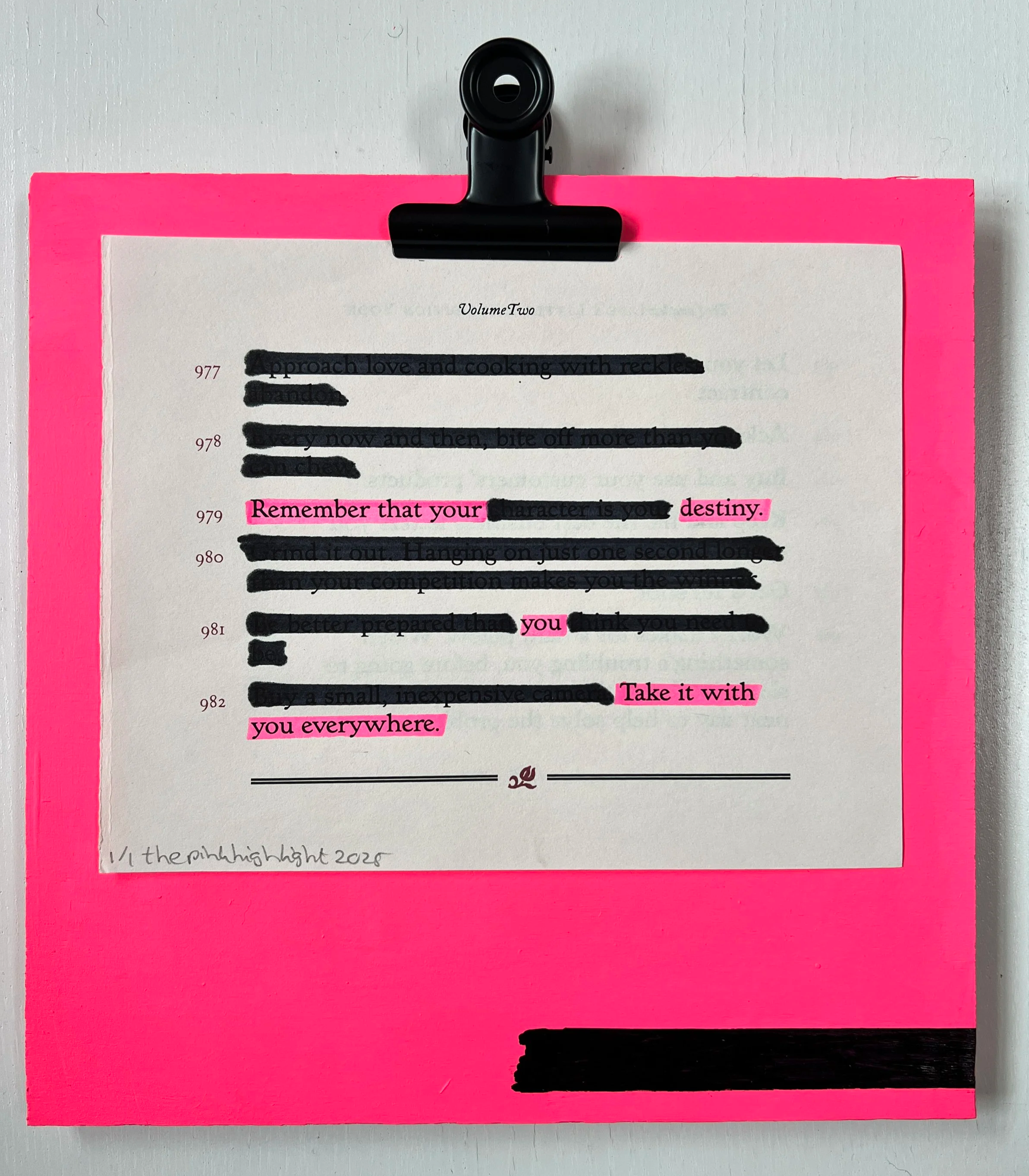 Close-up of a printed page clipped to a black binder clip with a bright pink border. The page contains a quote highlighted in pink: 'Remember that your destiny.' The rest of the text is blacked out with black ink. The document appears to be a written