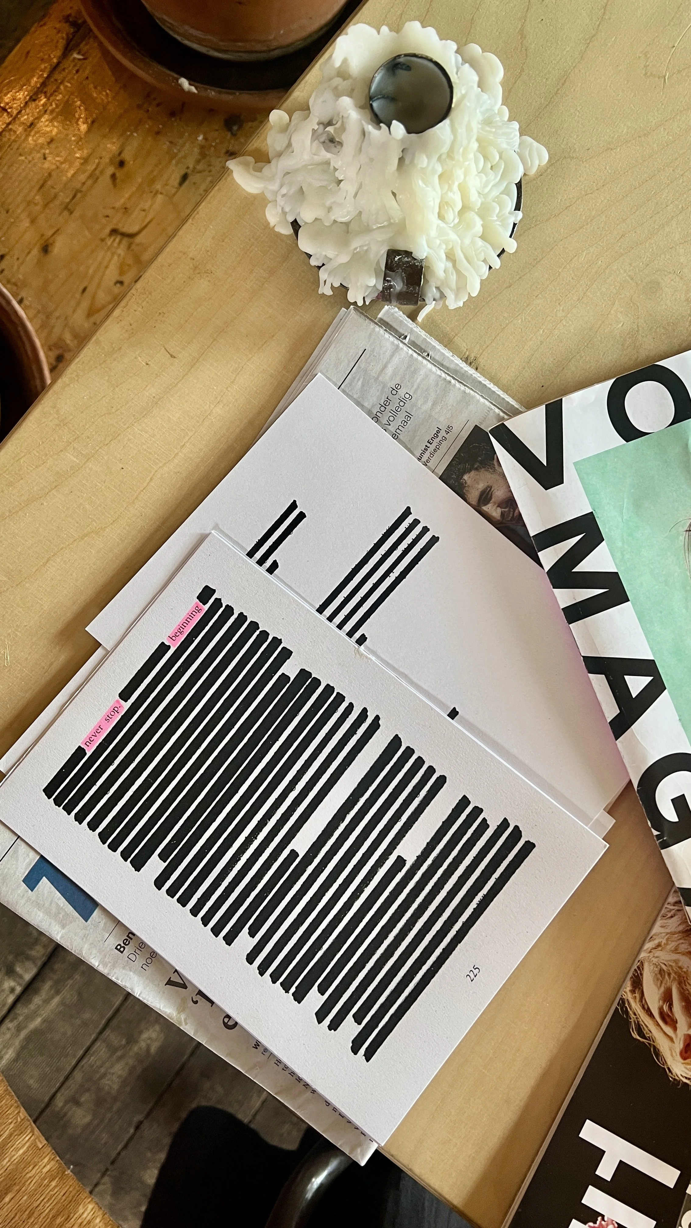 A paper with a large barcode, placed on a wooden table with other papers and magazines nearby.