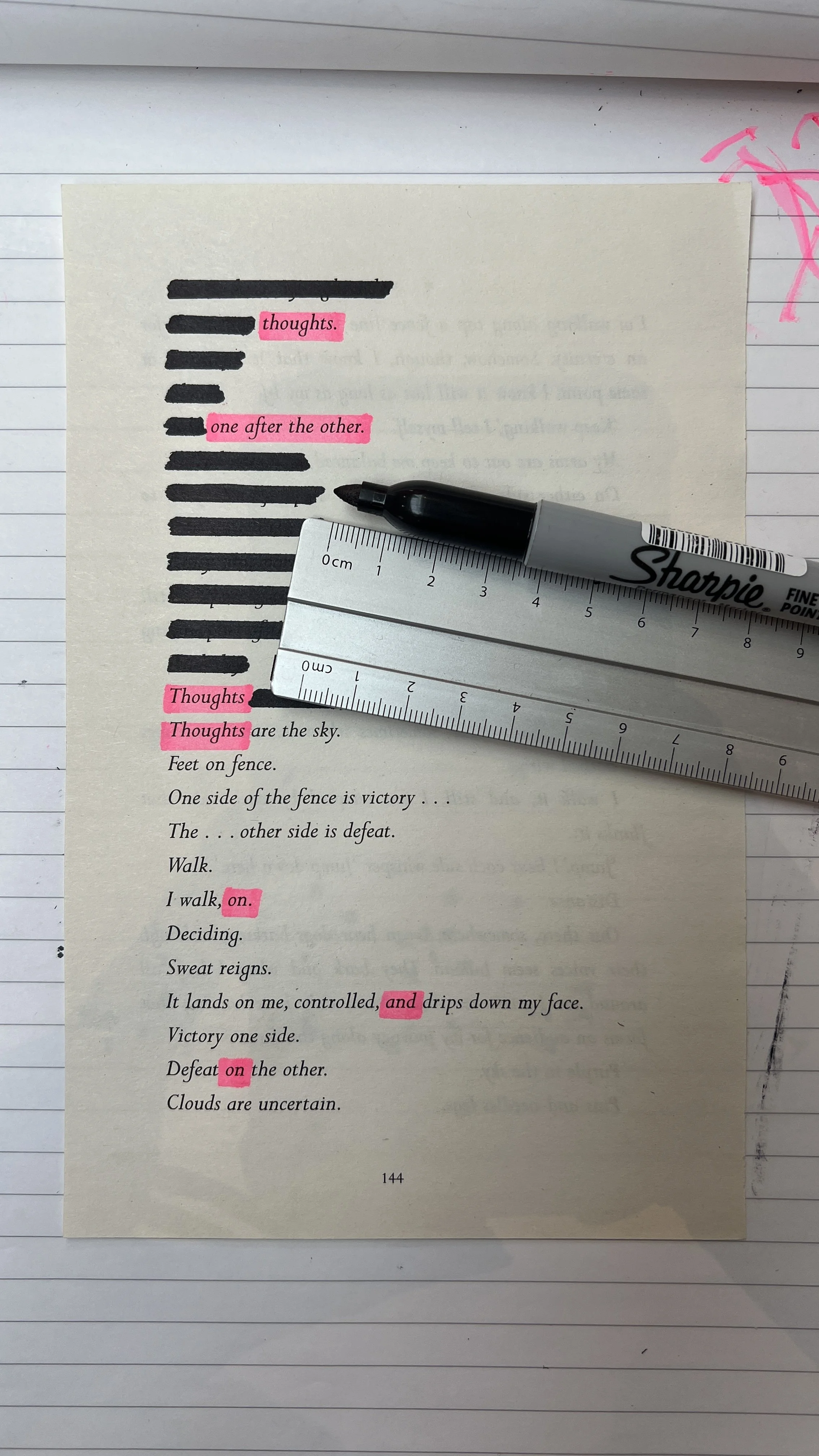 A page from a book with the poem 'Invictus' by William Ernest Henley, with several lines highlighted in pink, and a black marker and ruler placed on the page.