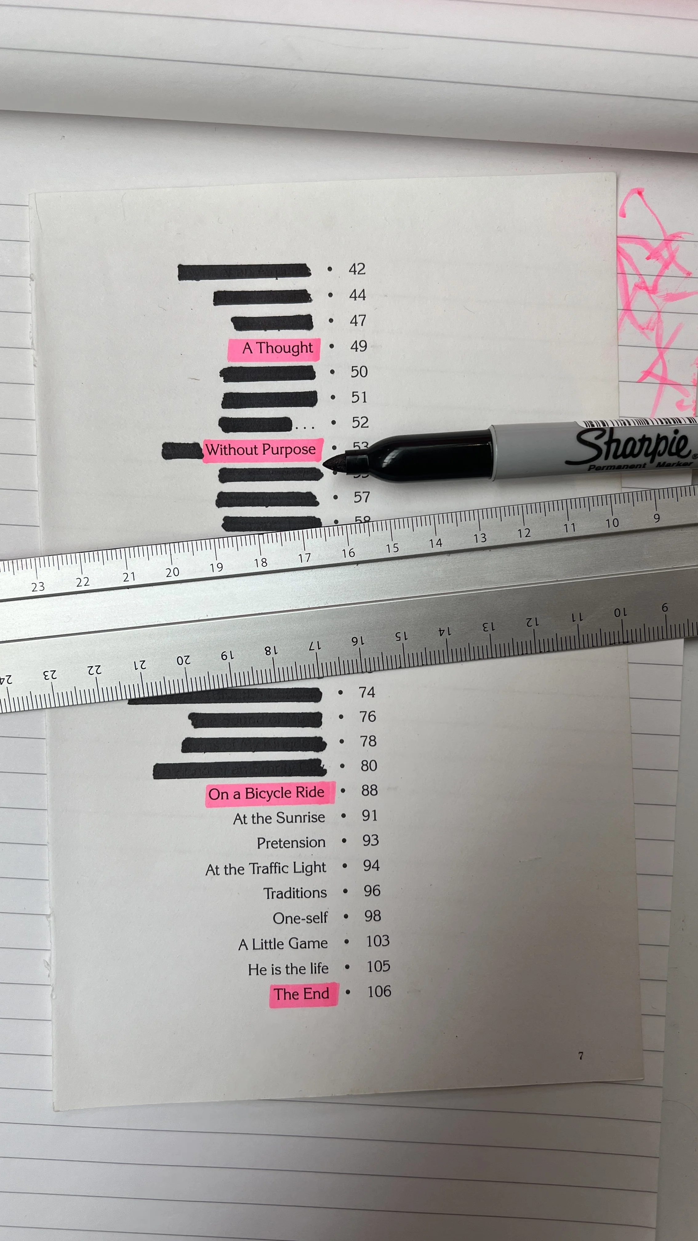 A printed page with a list of phrases in black text, some of which are highlighted in pink. Pink highlights include the phrases "A Thought," "Without Purpose," "On a Bicycle Ride," and "The End." The text is partially obscured by two rulers and a bla
