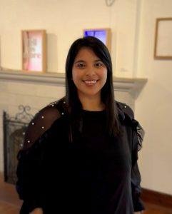 Woman in black smiling at camera