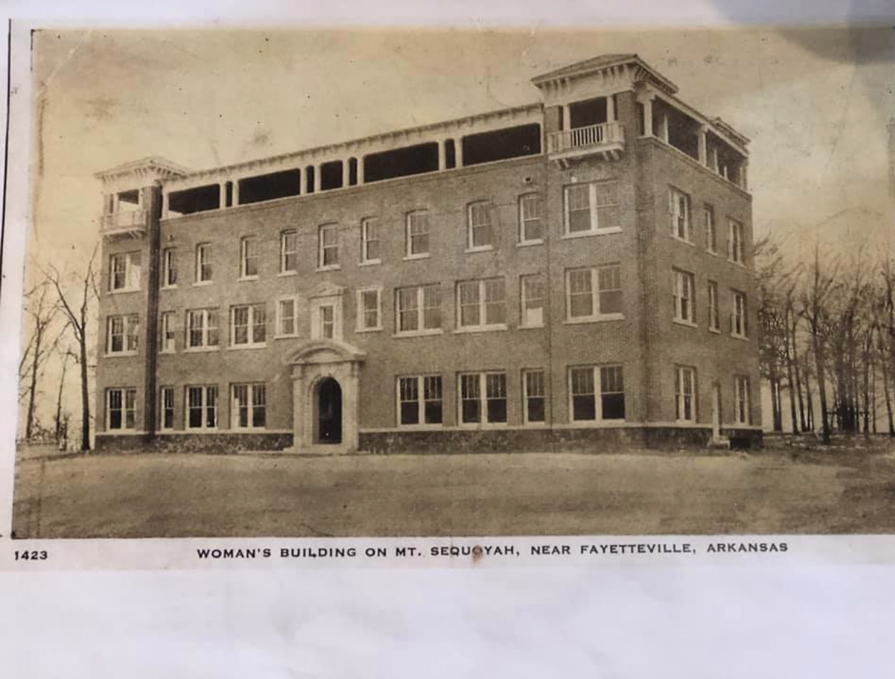 Old black-and-white photo of a large, multi-story woman's building on Mount Sequoyah near Fayetteville, Arkansas, with trees in the background.