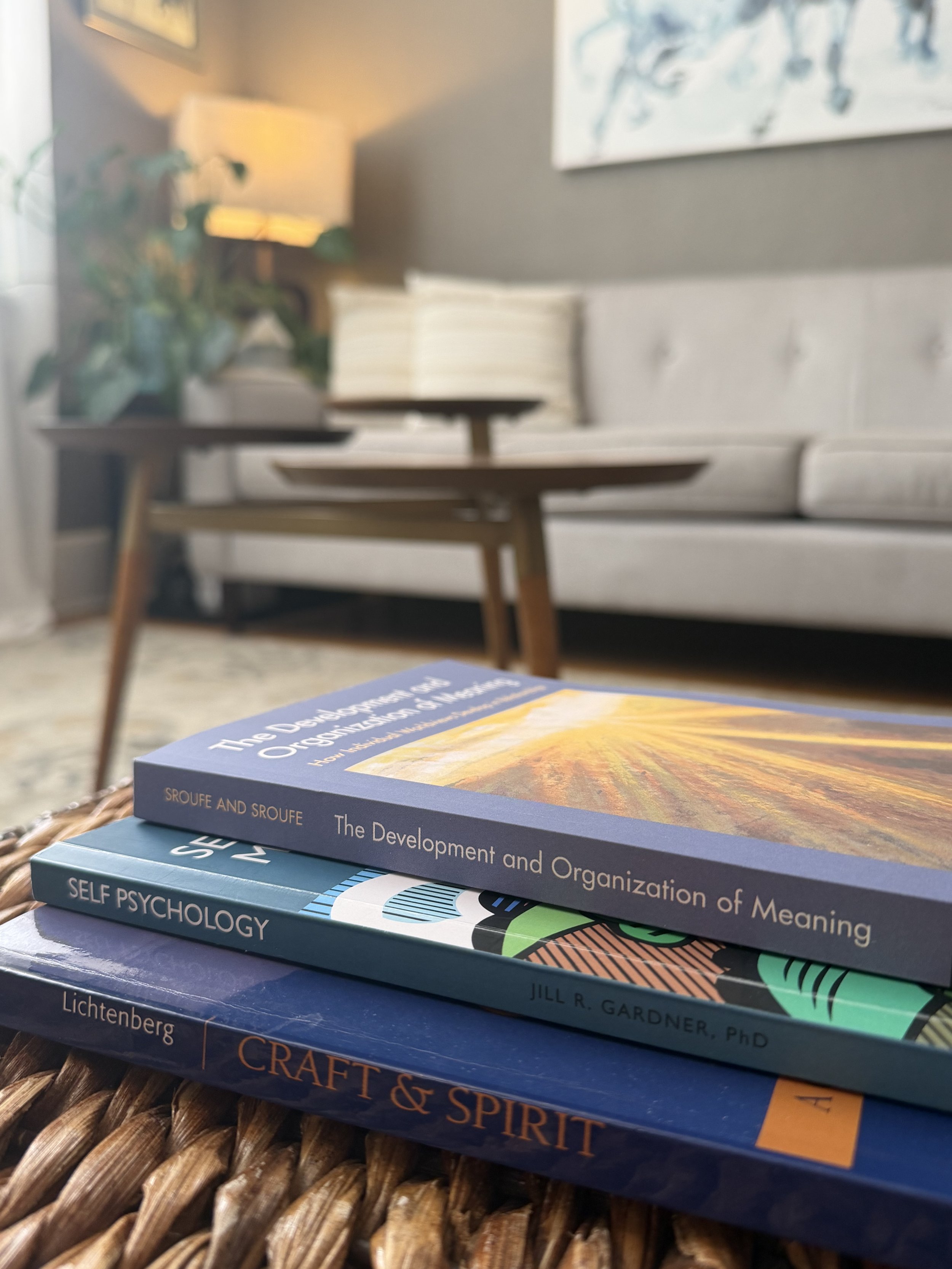 Psychology and psychoanalysis books in a quiet psychotherapy office setting.