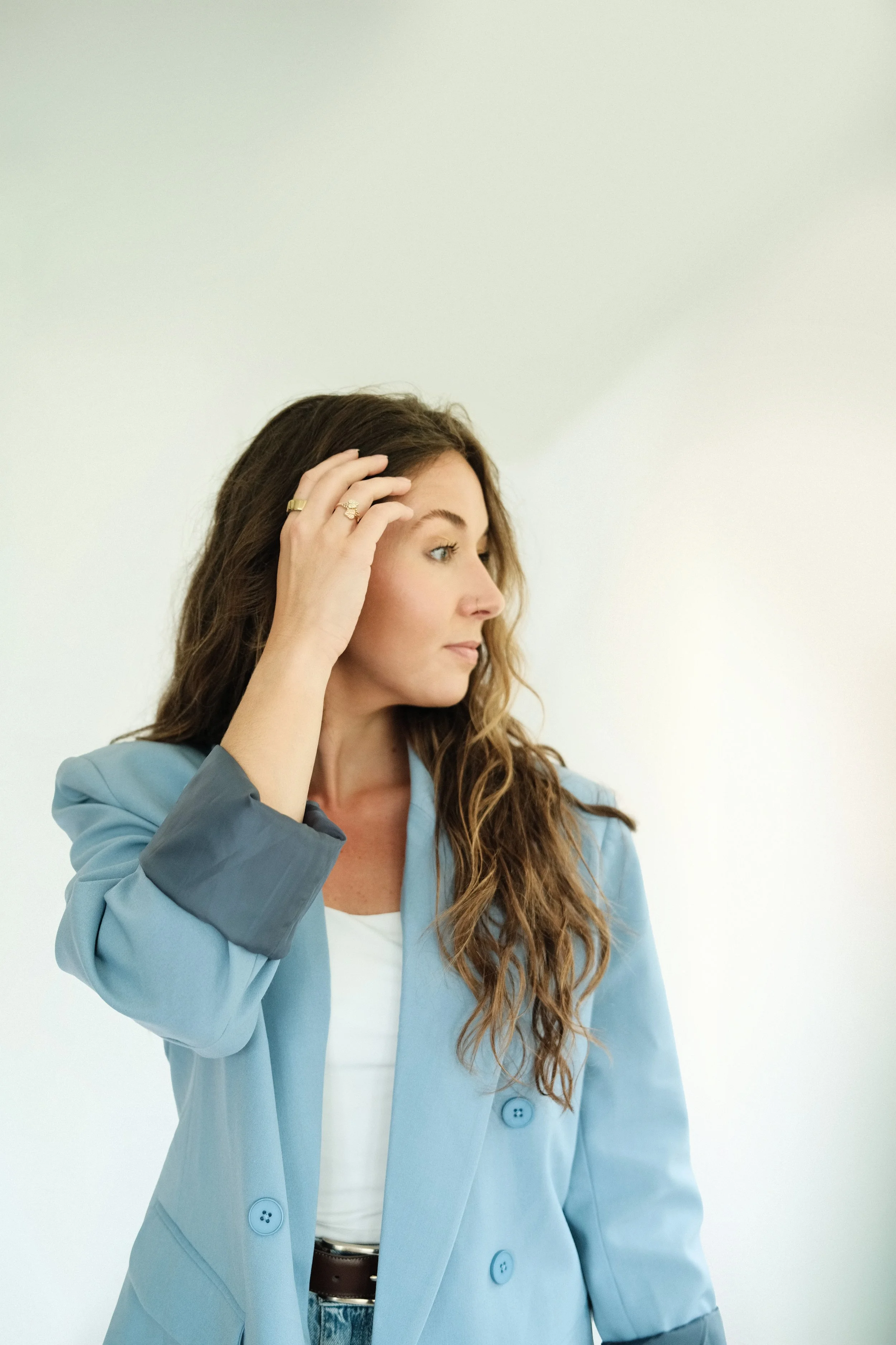 Candid portrait of Kara Lyons, founder and interior designer of Chapter V, wearing a blue blazer