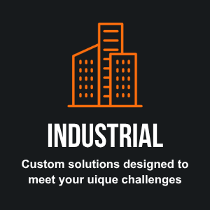 An orange outline of tall buildings against a black background, with the word "INDUSTRIAL" in bold white letters below and the phrase "Custom solutions designed to meet your unique challenges" underneath.
