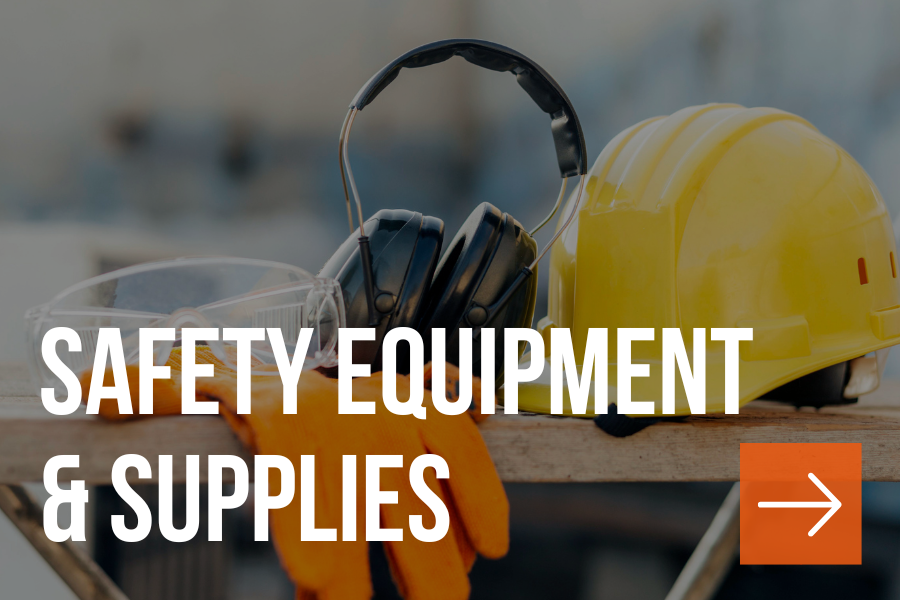 Safety equipment including a yellow hard hat, protective goggles, orange gloves, ear protection, and a dust mask on a workbench.