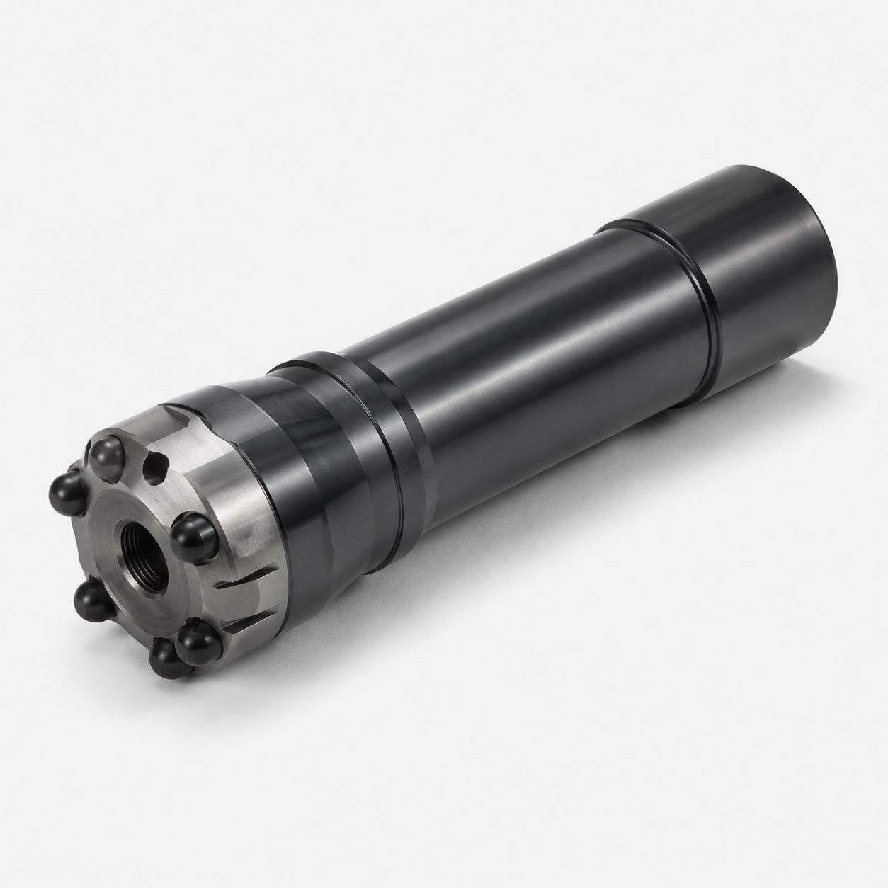 A cylindrical metal machine part with a threaded hole in the center, black spherical bolts around the metal end, and a black outer surface, resting on a white background.