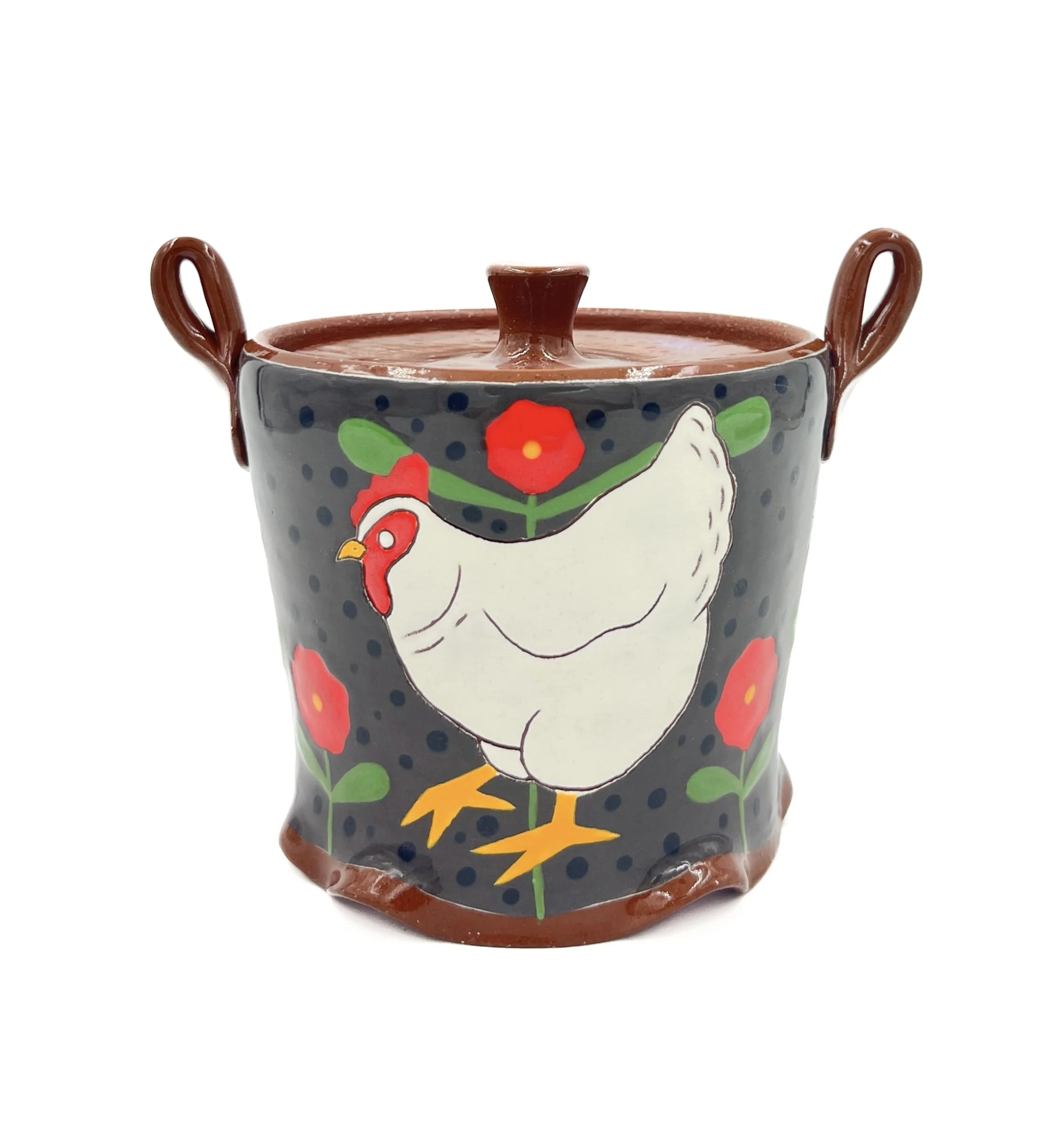 A painted ceramic mug with a rooster and floral design, featuring a brown top and handles, and a dark gray background decorated with red flowers, green leaves, and yellow accents.