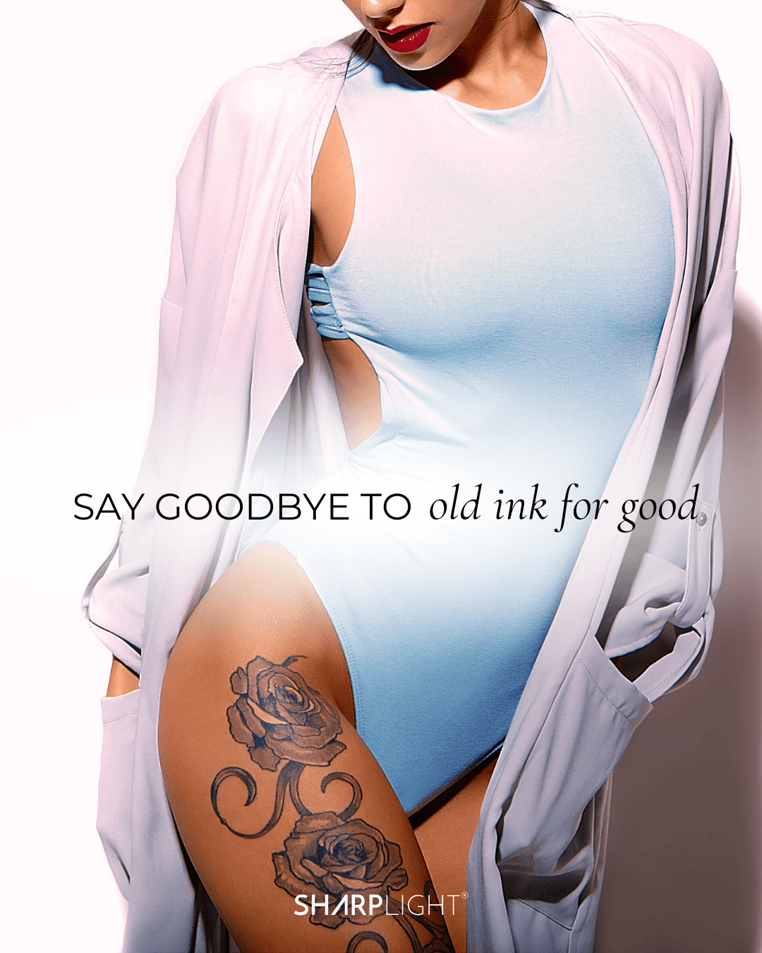 Close-up of a woman wearing a light blue bodysuit and a pink blazer, revealing a tattoo of roses on her thigh, with the text 'SAY GOODBYE TO old ink for good' and the SharpLight logo.
