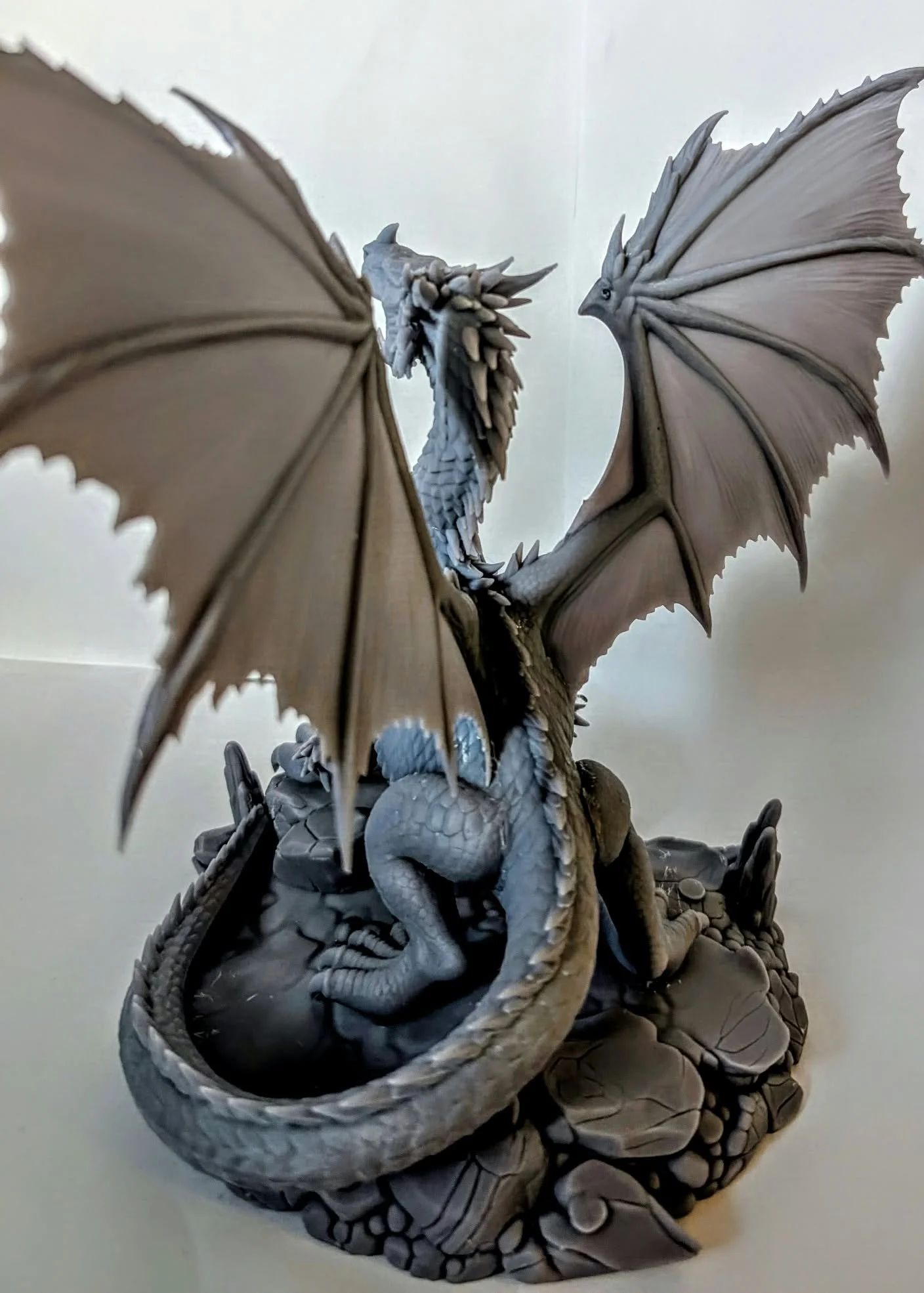 Adult Red Dragon resin miniature, unpainted, rear view showing the wing membranes and coiled tail