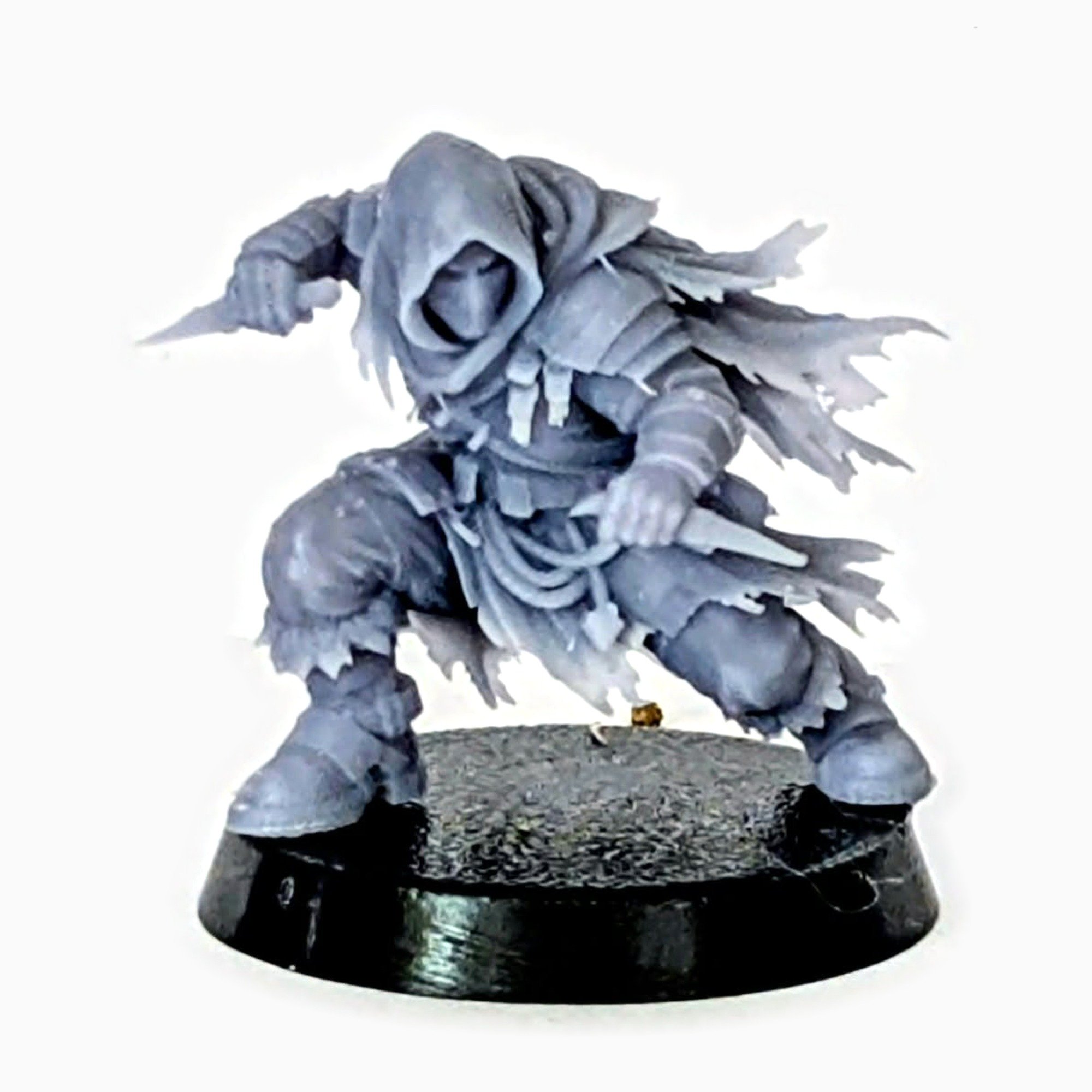 Hooded Rogue miniature crouched with two daggers, unpainted resin