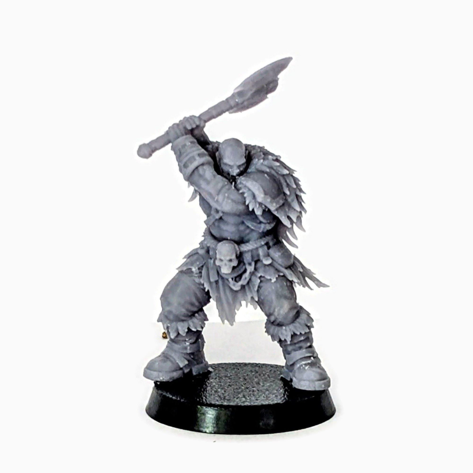 Barbarian miniature swinging a double-headed axe, unpainted resin