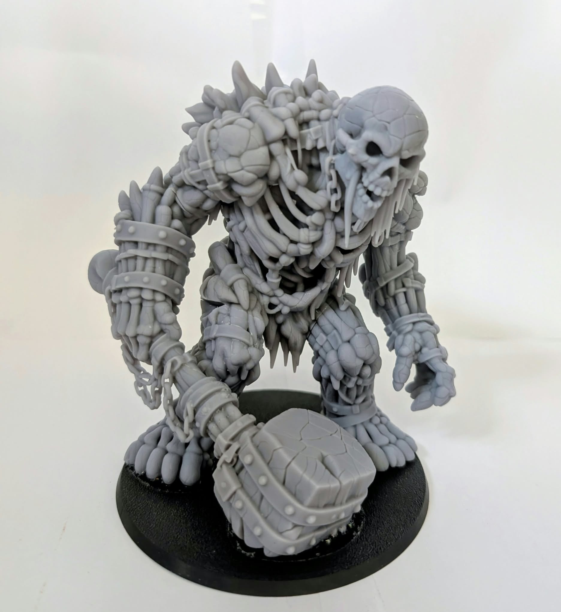 Undead Colossus resin miniature, unpainted, front view: a skeletal giant with chained limbs and a massive hammer
