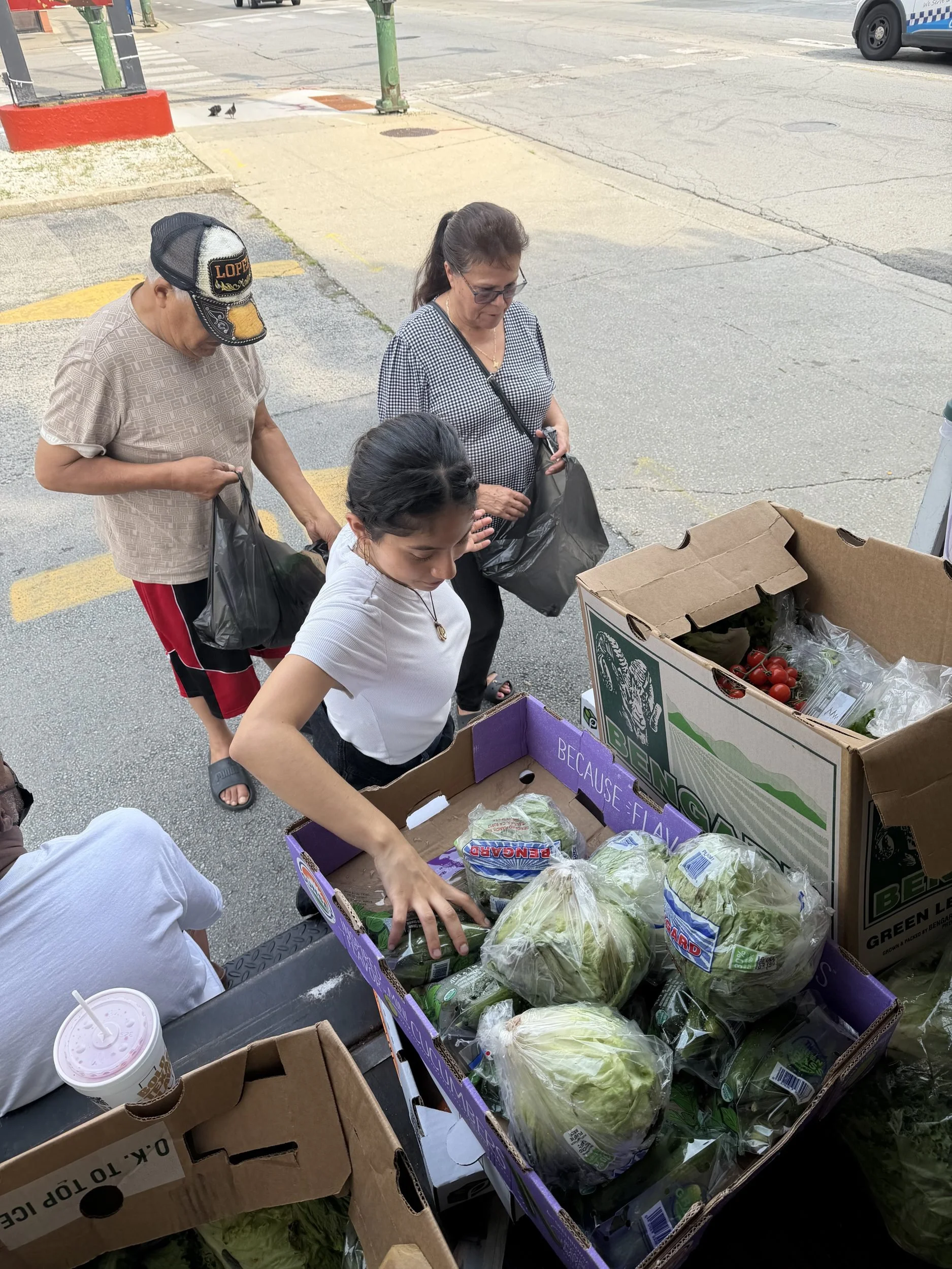 Neighbors choosing fresh produce and groceries at a Port Ministries food distribution in Back of the Yards