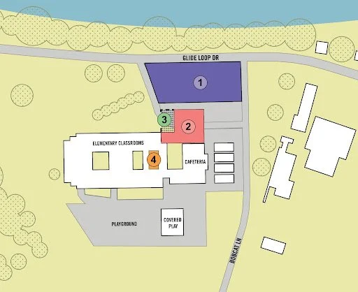 A school campus map showing elementary classrooms, playground, cafeteria, parking, and surrounding roads.