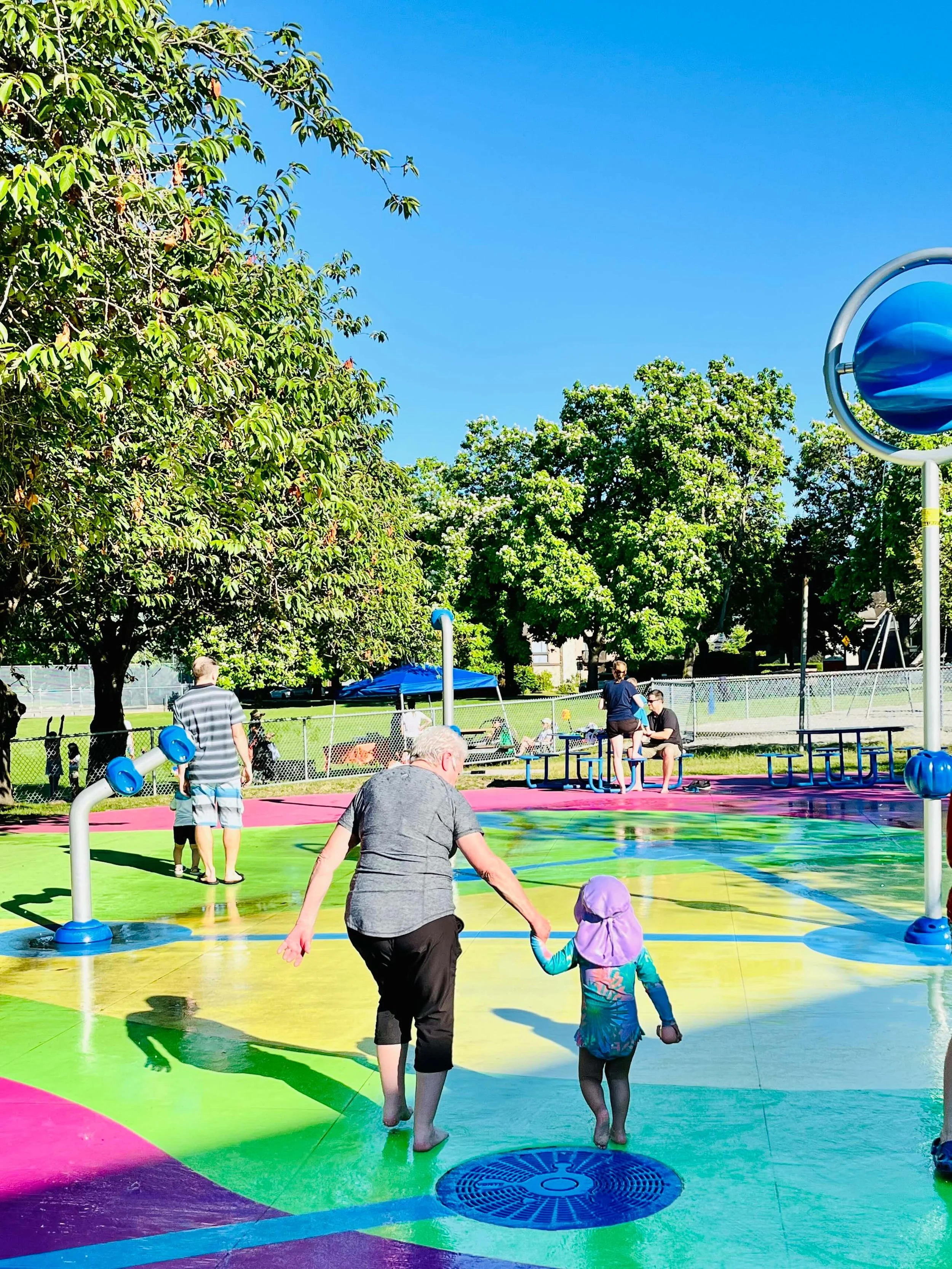 Connaught Park_ spray park_ kid with grandmother.jpeg