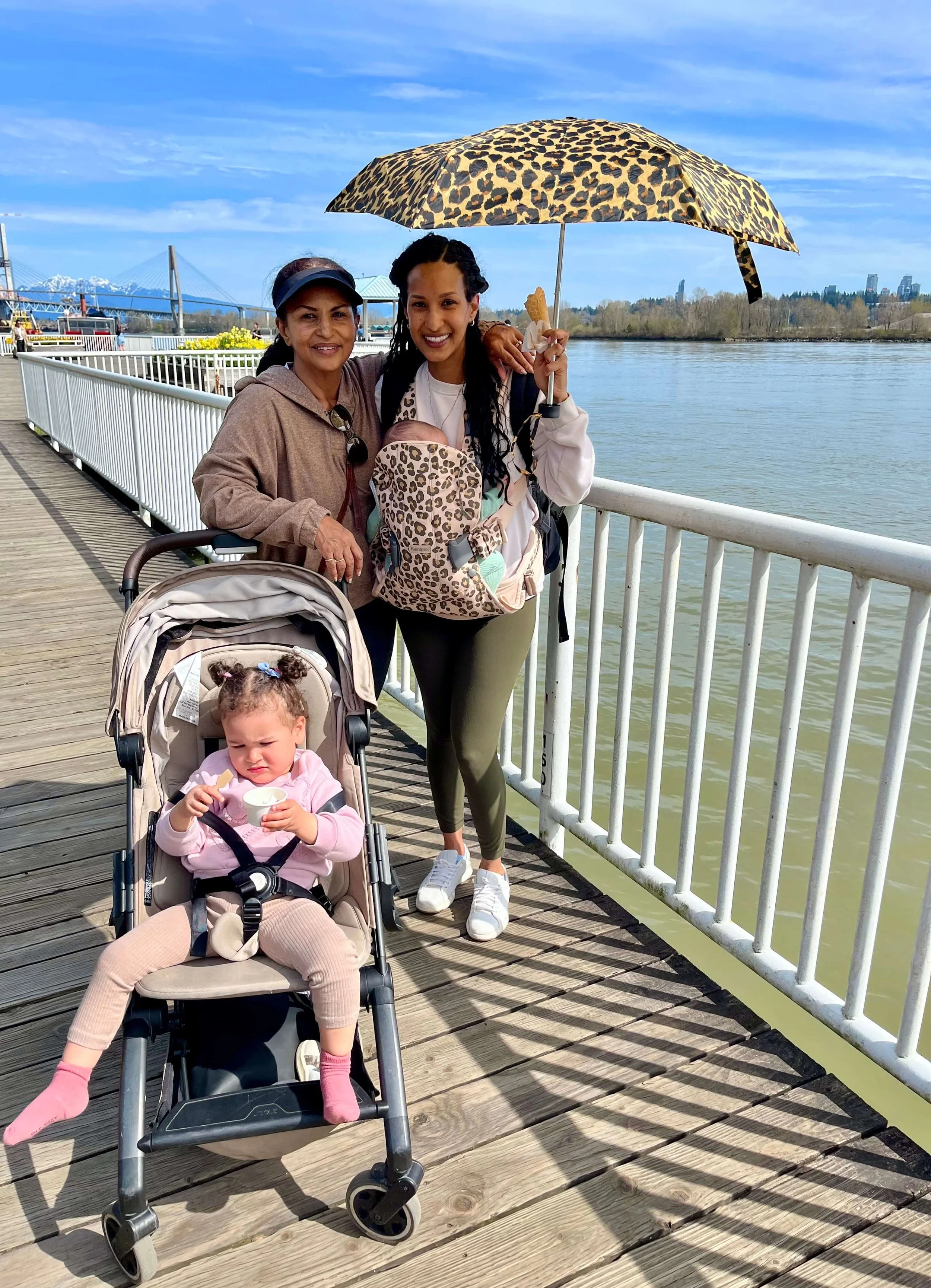 Grandmother, daughter and grandkids walking on New Westminster Quay on a sunny day