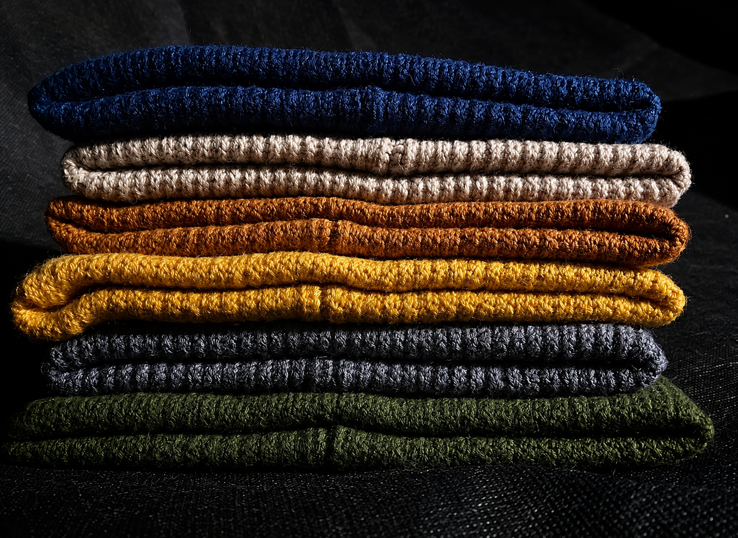 Stacked merino wool toques in navy, beige, mustard and grey