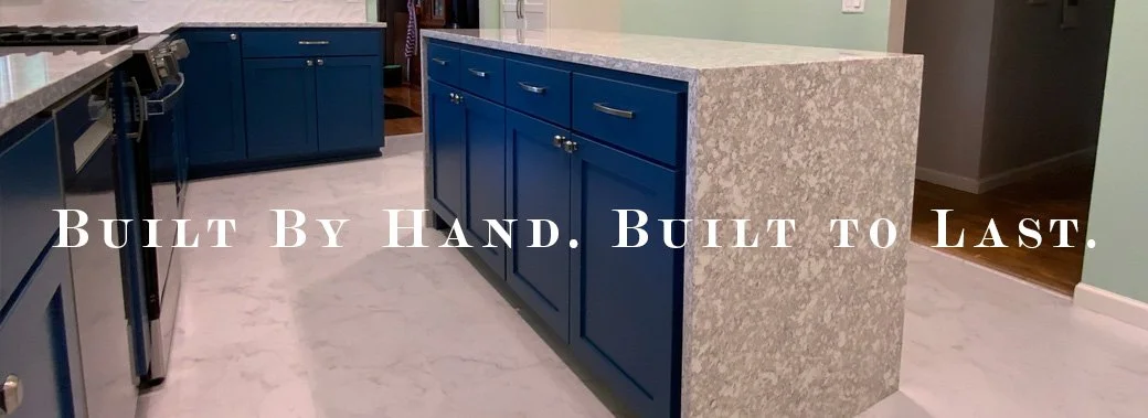Kitchen with blue cabinets and a small granite-topped island