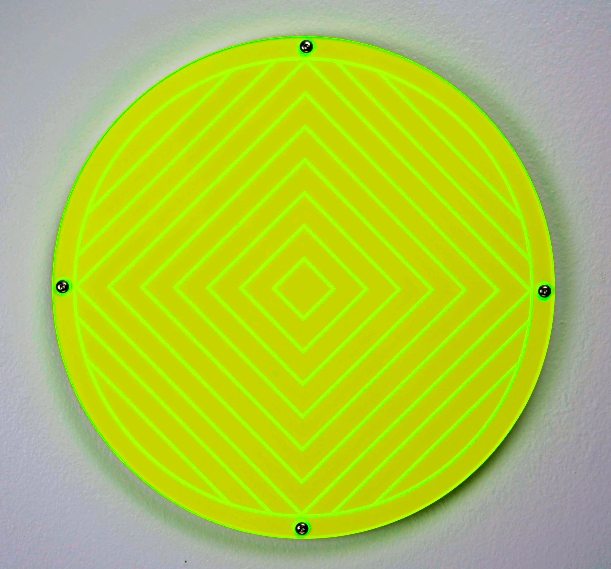 CO2 laser cut yellow reflective circular sign with neon green geometric patterns, custom laser cutting by MC Laser Labs.