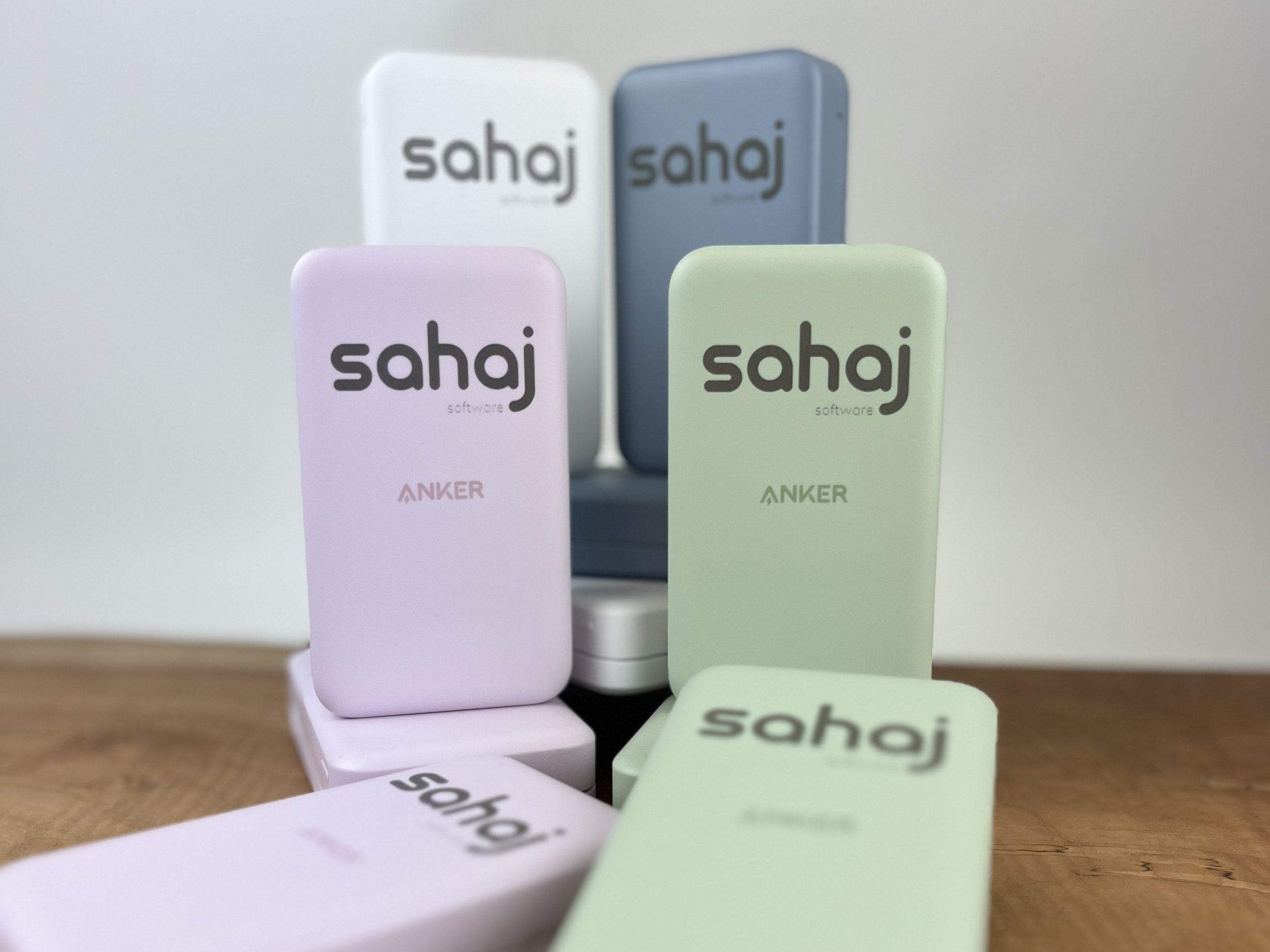 Colorful rectangular blocks with the word 'sahaj' and 'software' printed on them, arranged on a wooden surface.