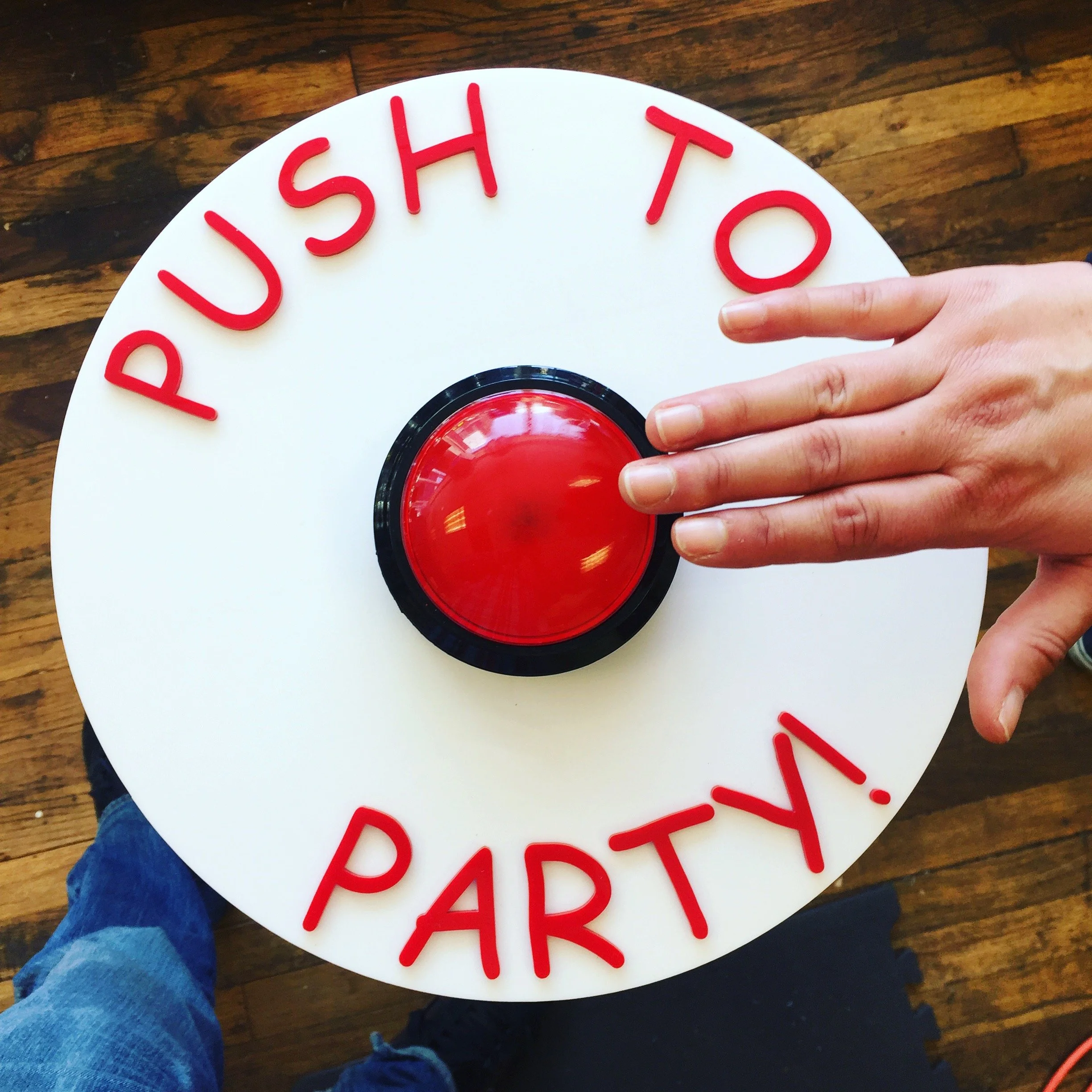 CO2 laser cut and engraved red 'PUSH TO PARTY' button sign, custom laser cutting and engraving by MC Laser Labs.