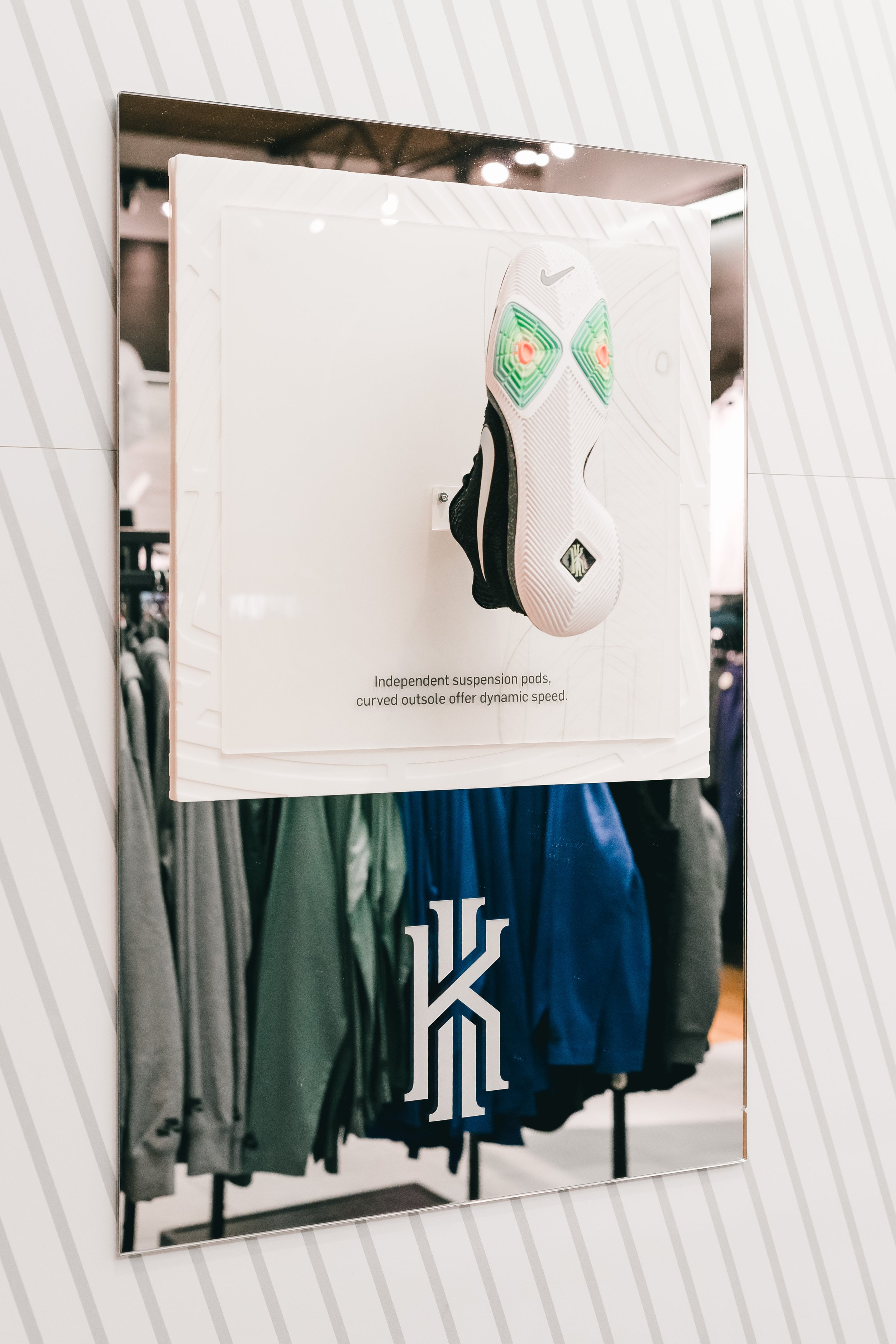 Retail store Kyrie Irving Nike shoe display with printed acrylic and mirrored acrylic layers and shoe riser. Custom fabrication, printing and laser engraving by MC Laser Labs