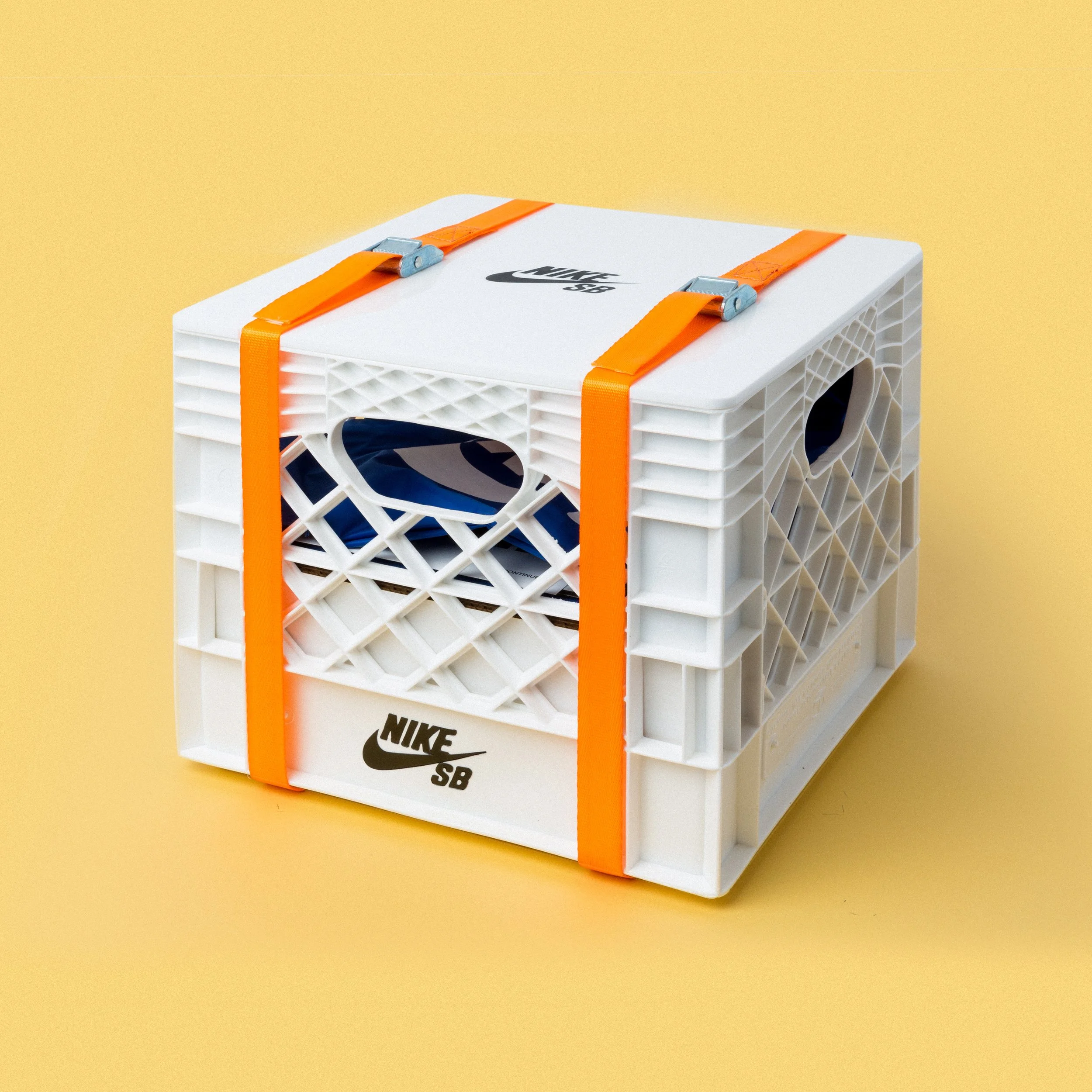 Nike SB milk crate basketball hoop seeding kit box, white plastic crate with Nike SB logo strapped in orange bands, custom fabrication by MC Laser Labs.