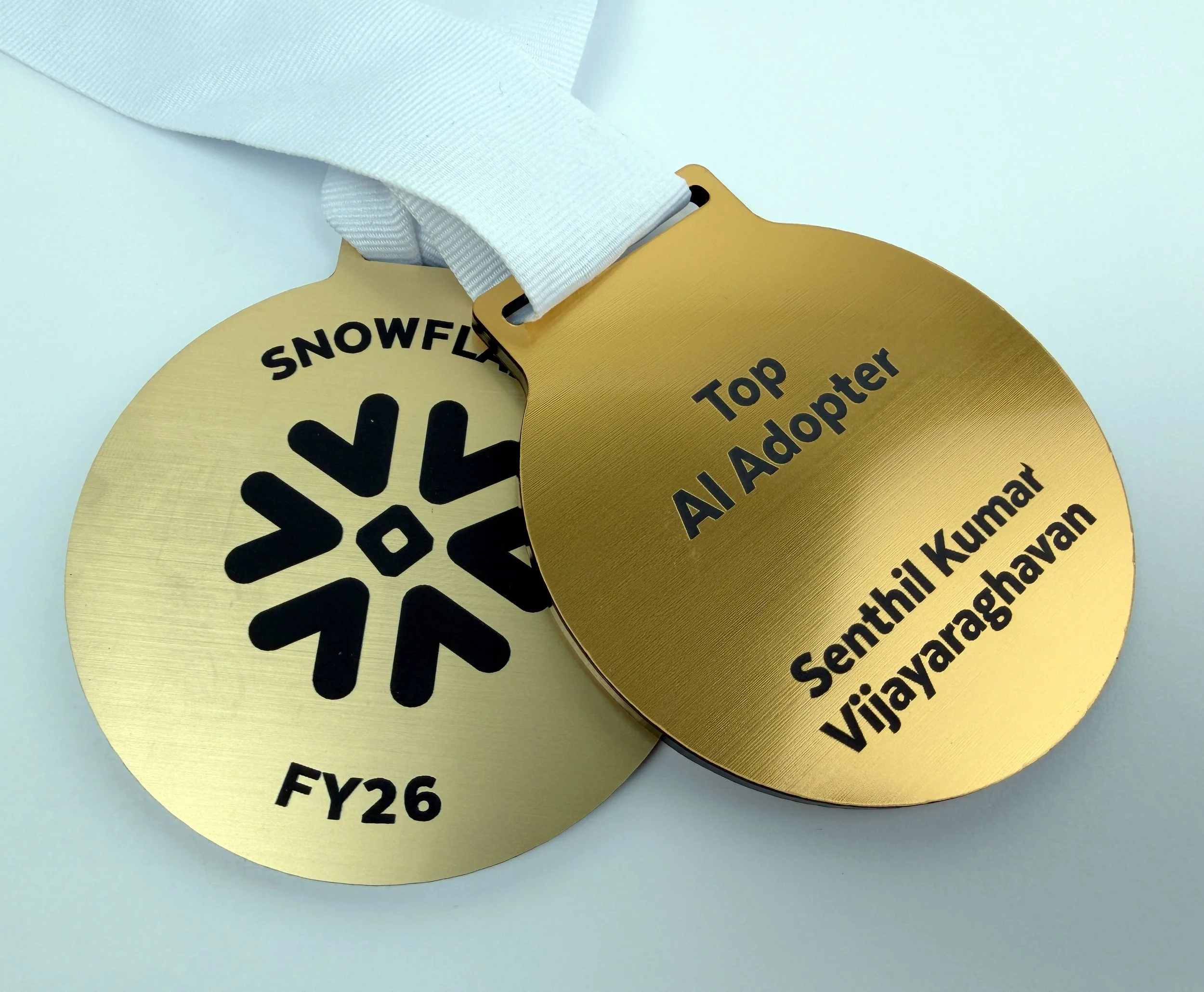 Gold circular adhesive labels with black text on a fabric strap, custom laser cutting and printing by MC Laser Labs.