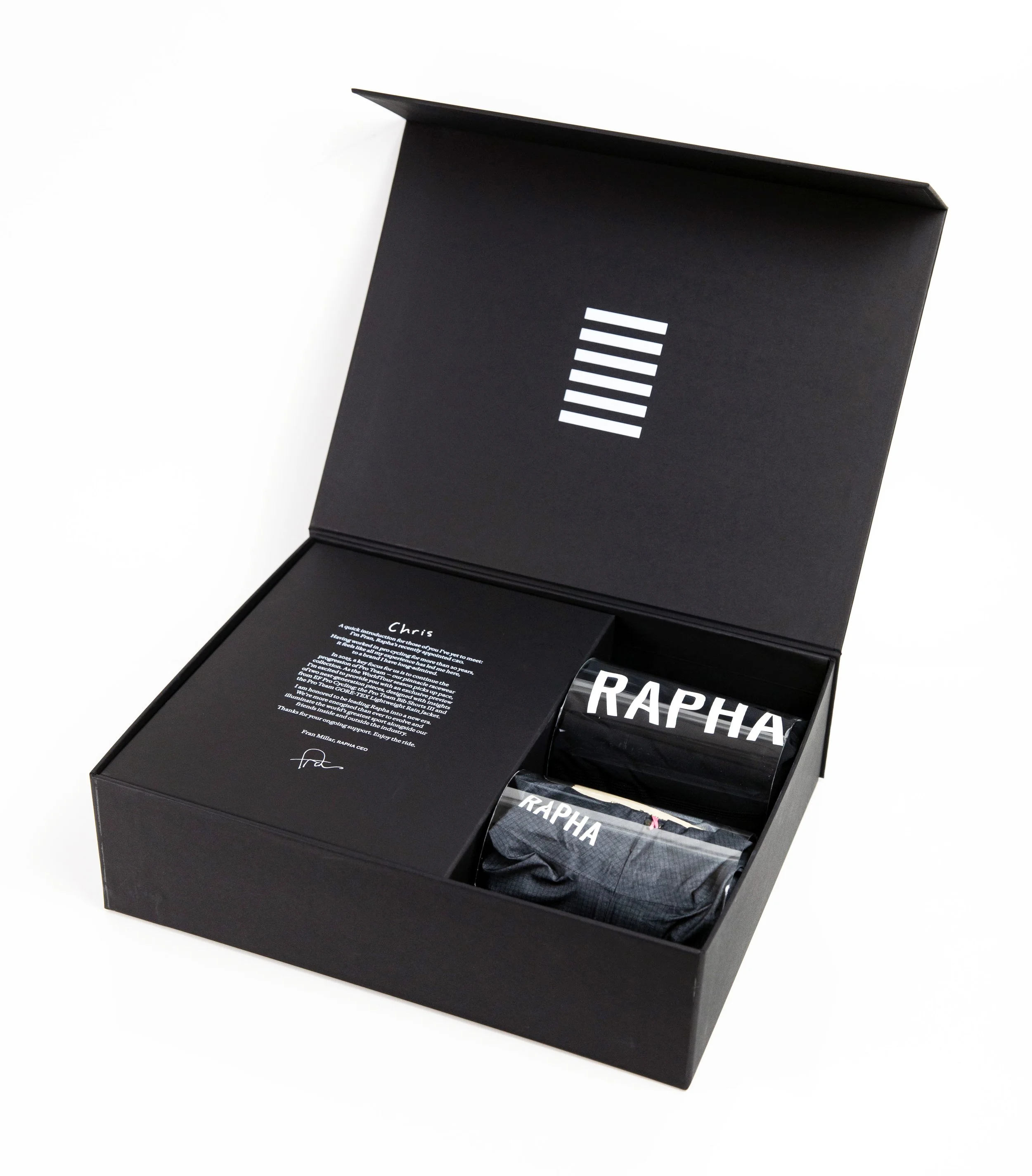 Rapha turned edge seeding kit box, open with folded branded clothing and a letter from the Rapha CEO inside, custom fabrication by MC Laser Labs.