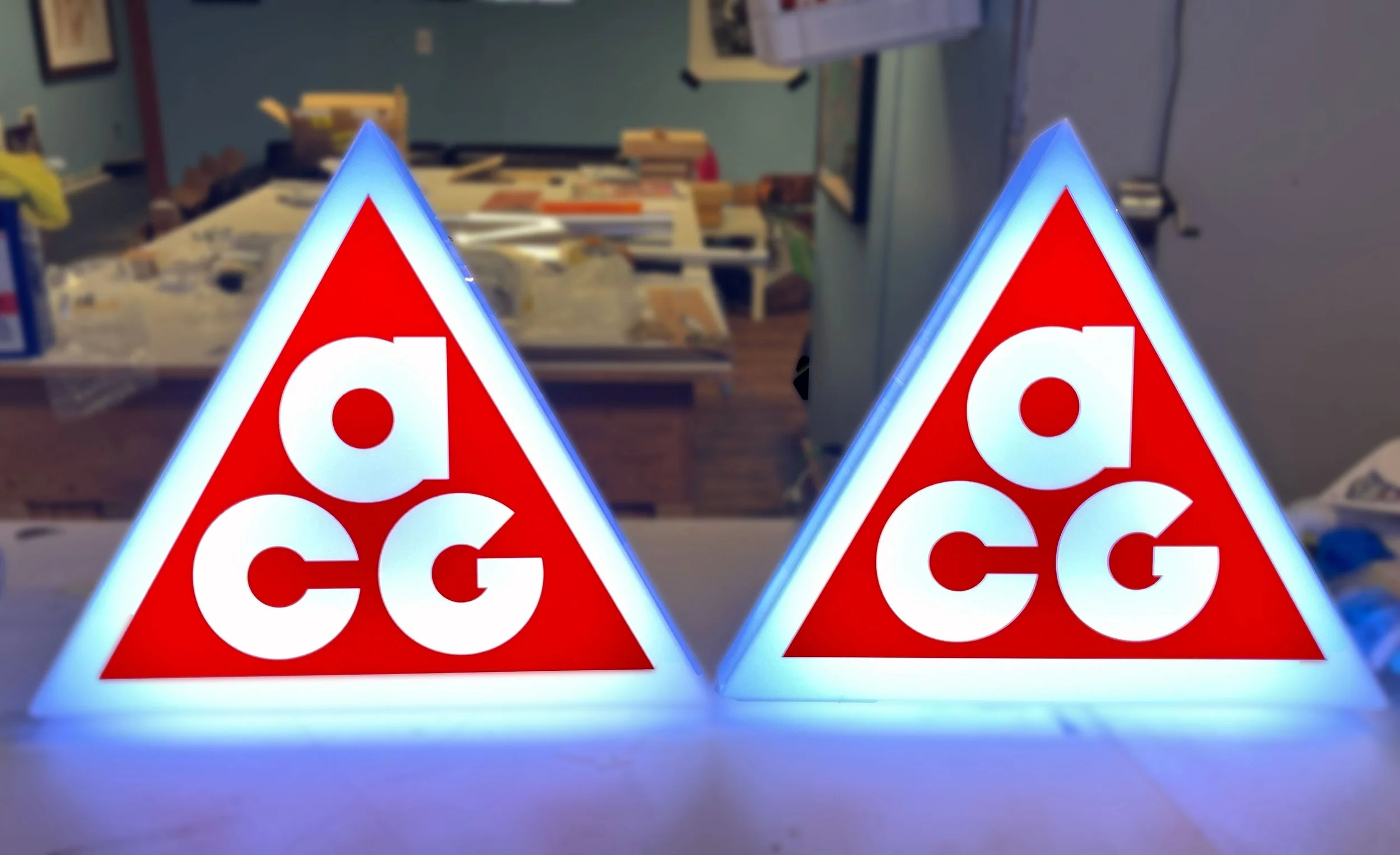 CO2 laser cut illuminated Nike ACG sign with printed orange on acrylic custom fabrication by MC Laser Labs.