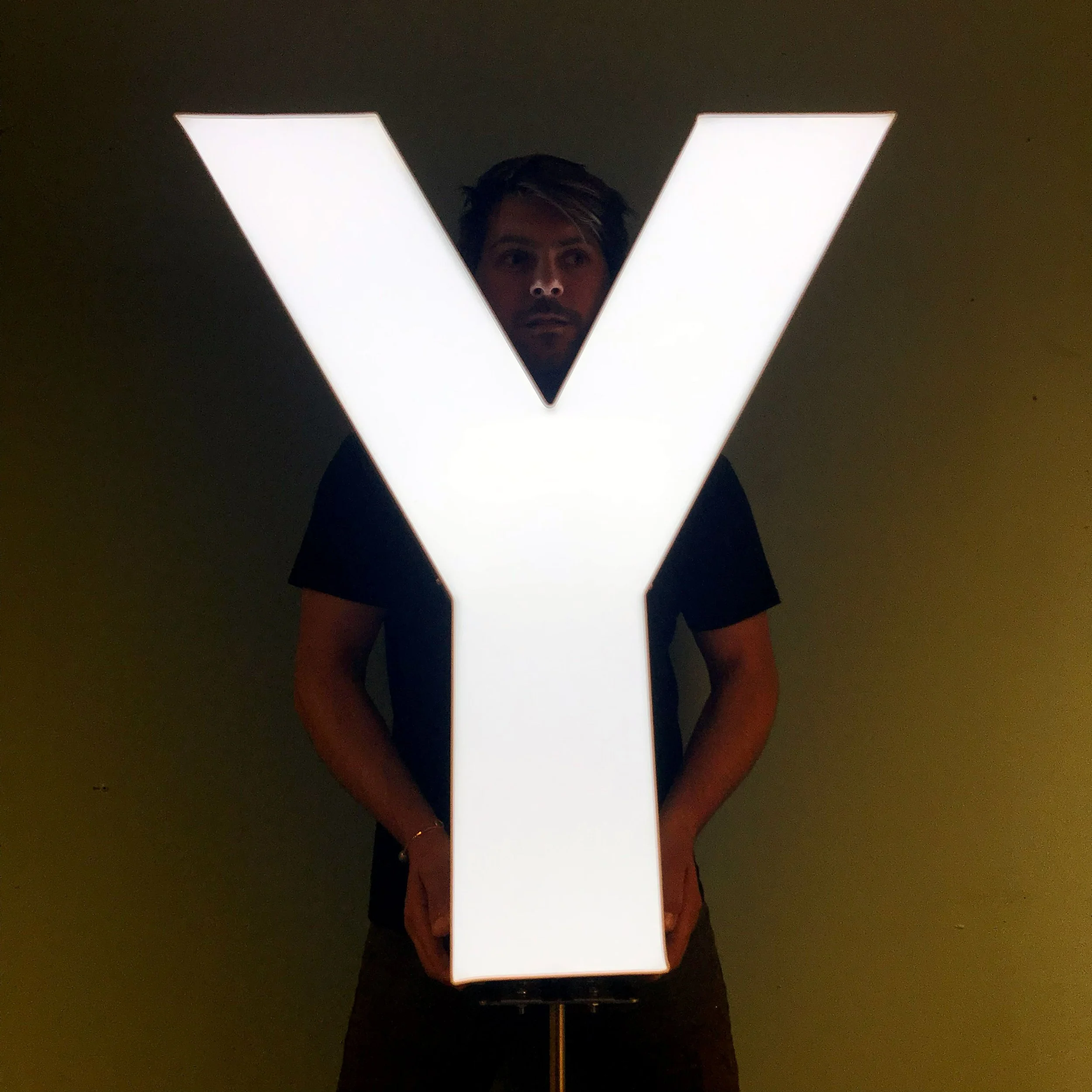 A large illuminated custom channel letter 'Y' sign, custom fabrication by MC Laser Labs.