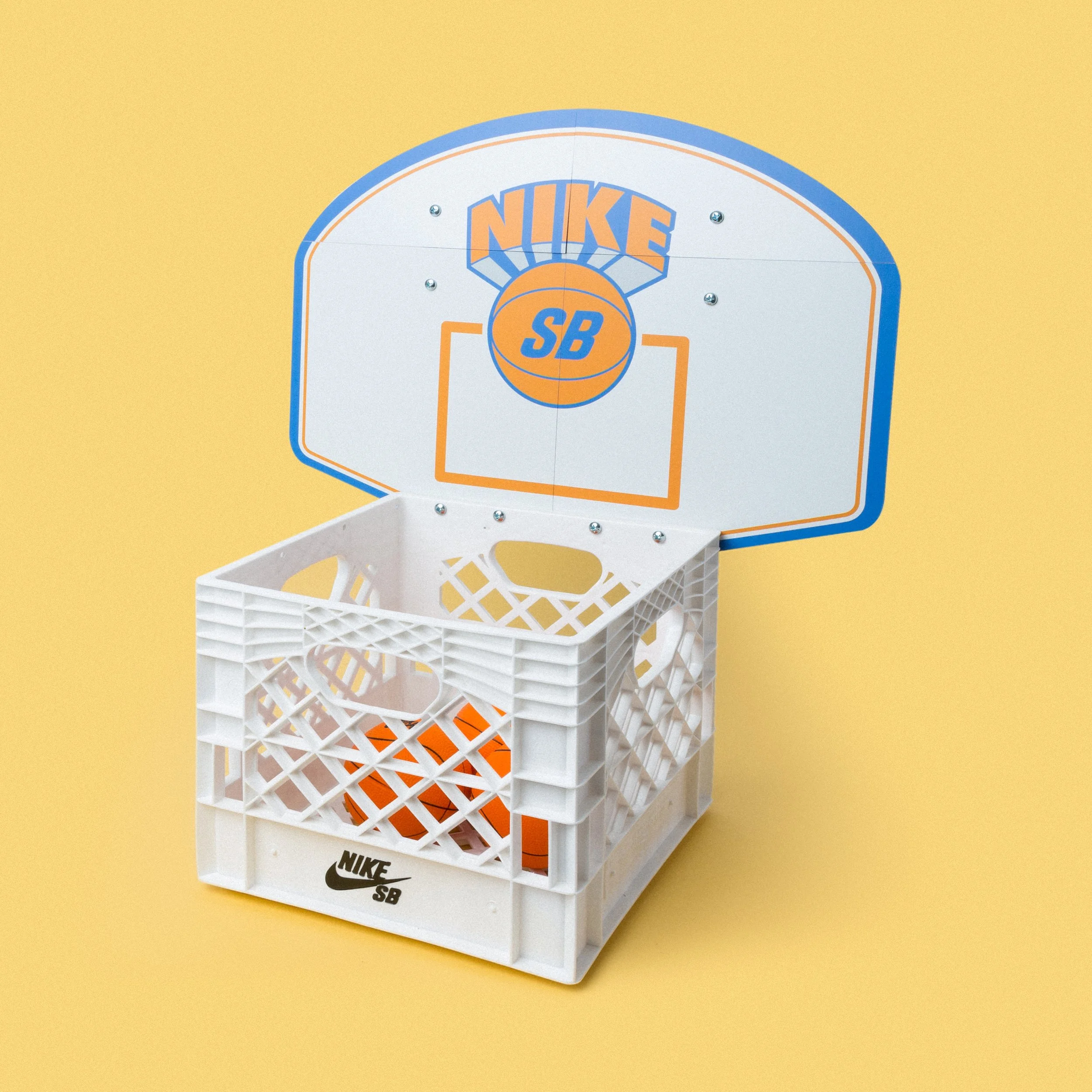 Nike SB mini basketball hoop seeding kit attached above a white plastic storage basket, custom fabrication by MC Laser Labs.