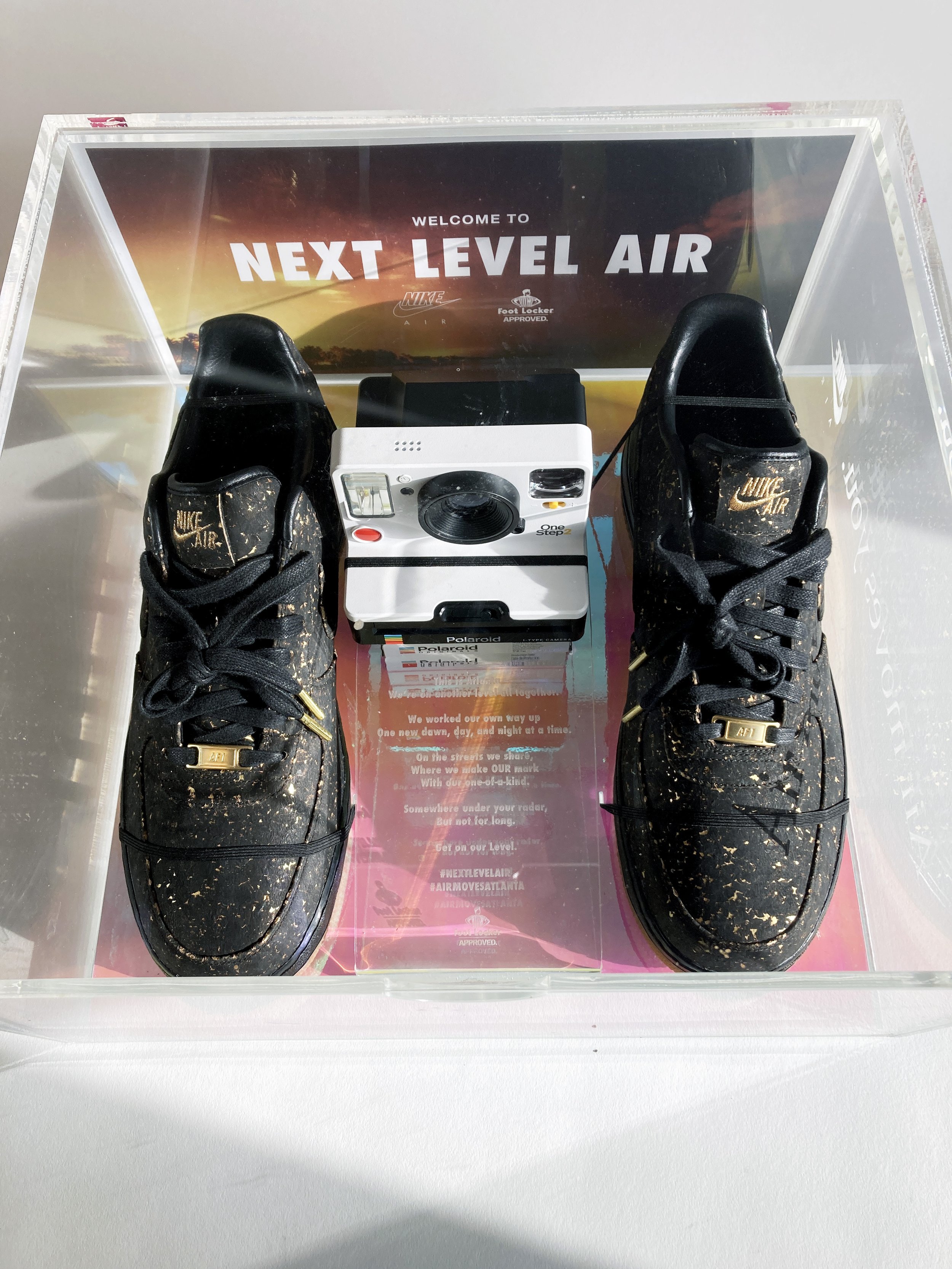 Nike 'Next Level Air' acrylic seeding kit box with black Nike Air sneakers, Polaroid camera, custom fabrication by MC Laser Labs.