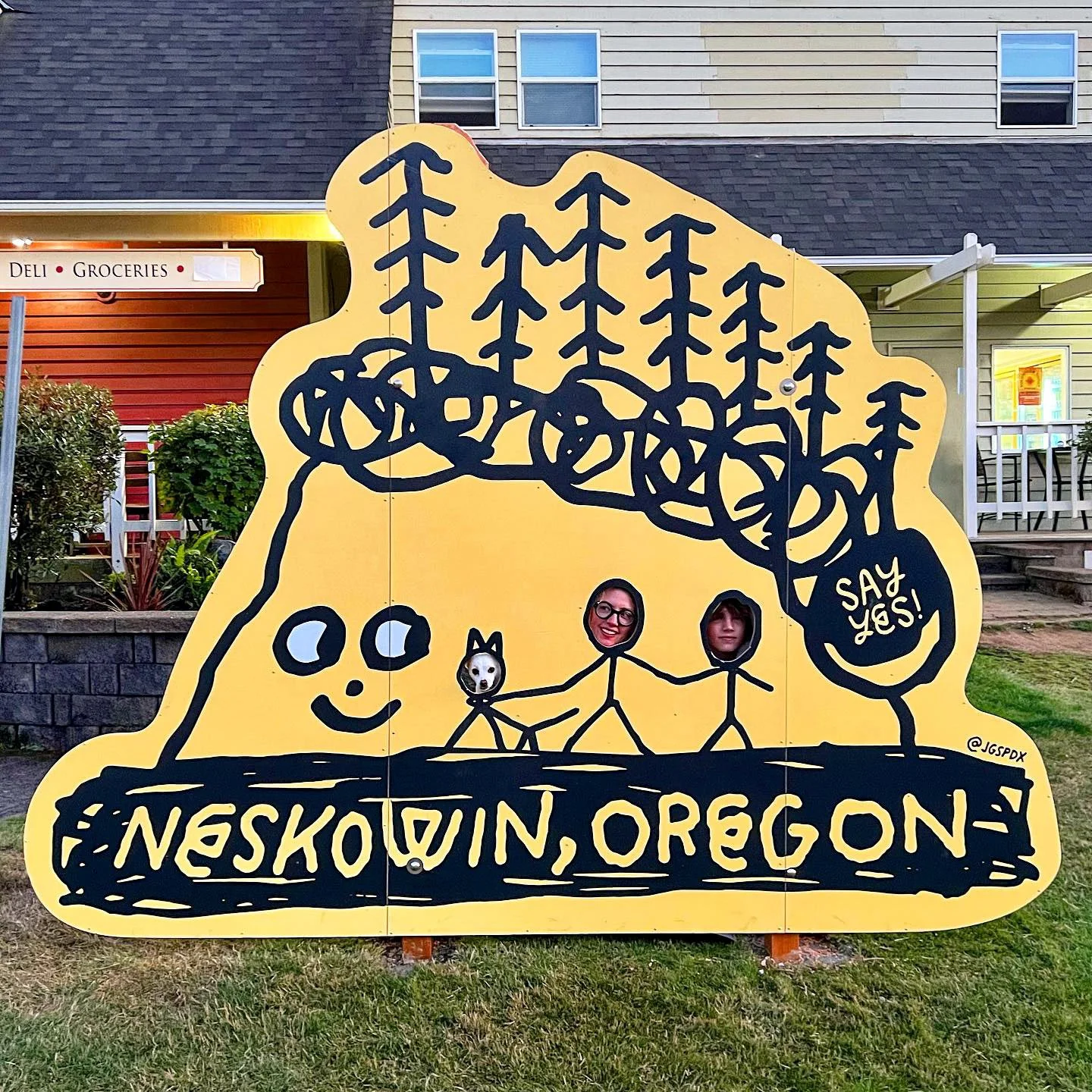 Custom printed Dibond and fabrication for an outdoor display in Neskowin, Oregon with a stylized tree outline and cutout figures drawn by Jason Stugill. custom fabrication, printing and laser cutting and engraving by MC Laser Labs.