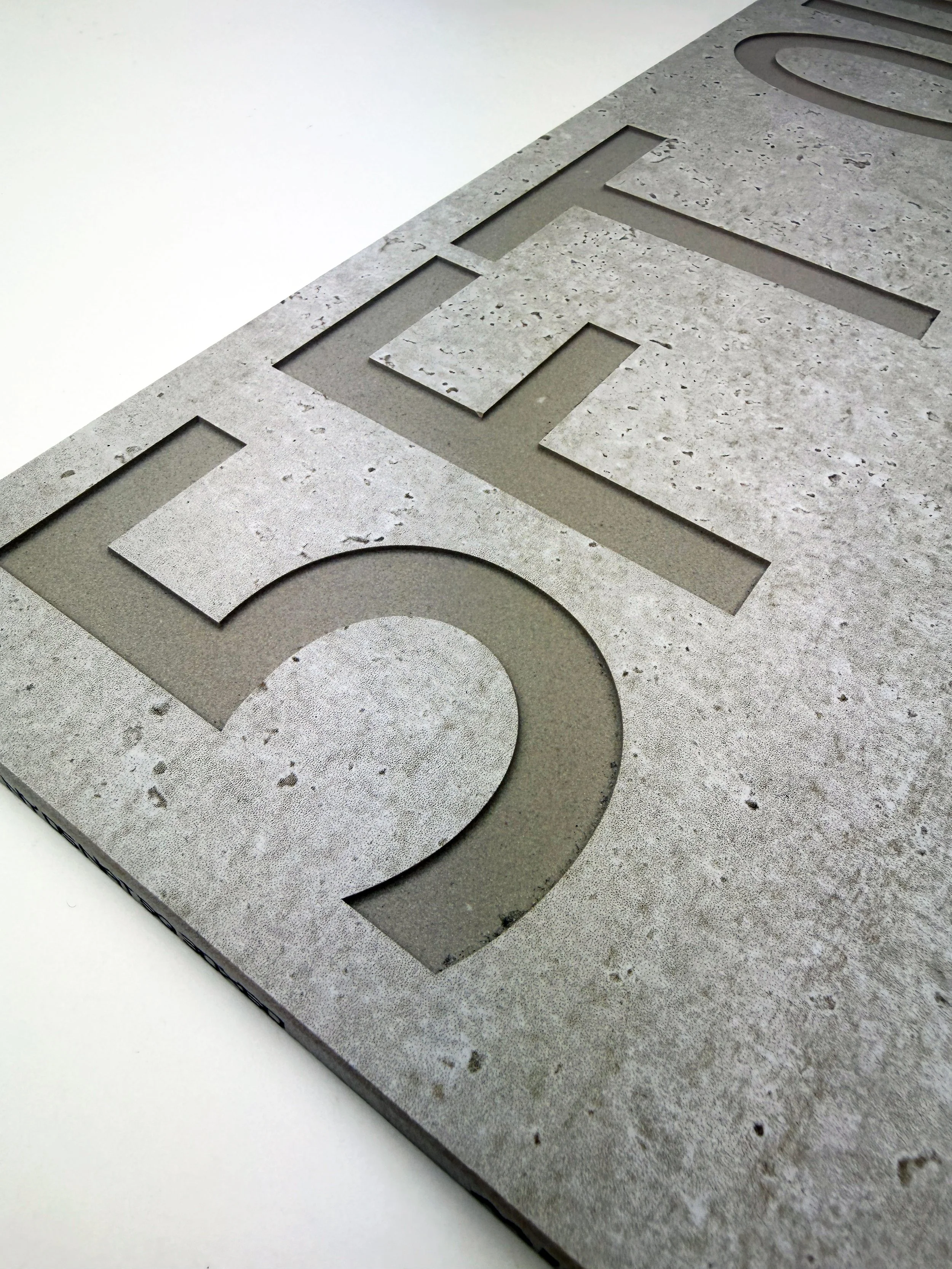 Close-up of a stone or concrete surface with cut-out letters forming the word 'OFF.'