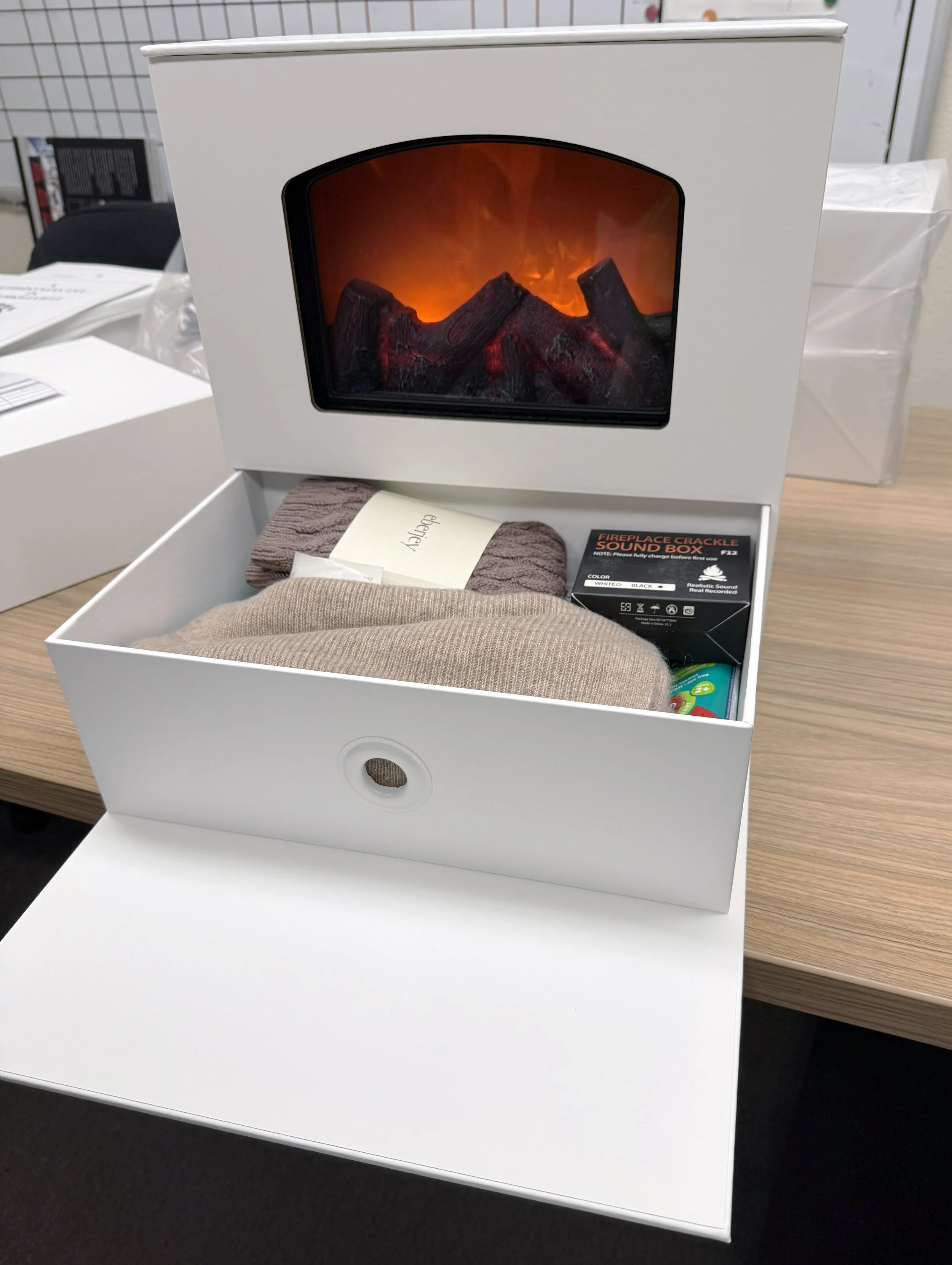 White turned edge light-up seeding kit box shaped like a fireplace with a 'Fireplace Crackle Sound Box', custom fabrication by MC Laser Labs.