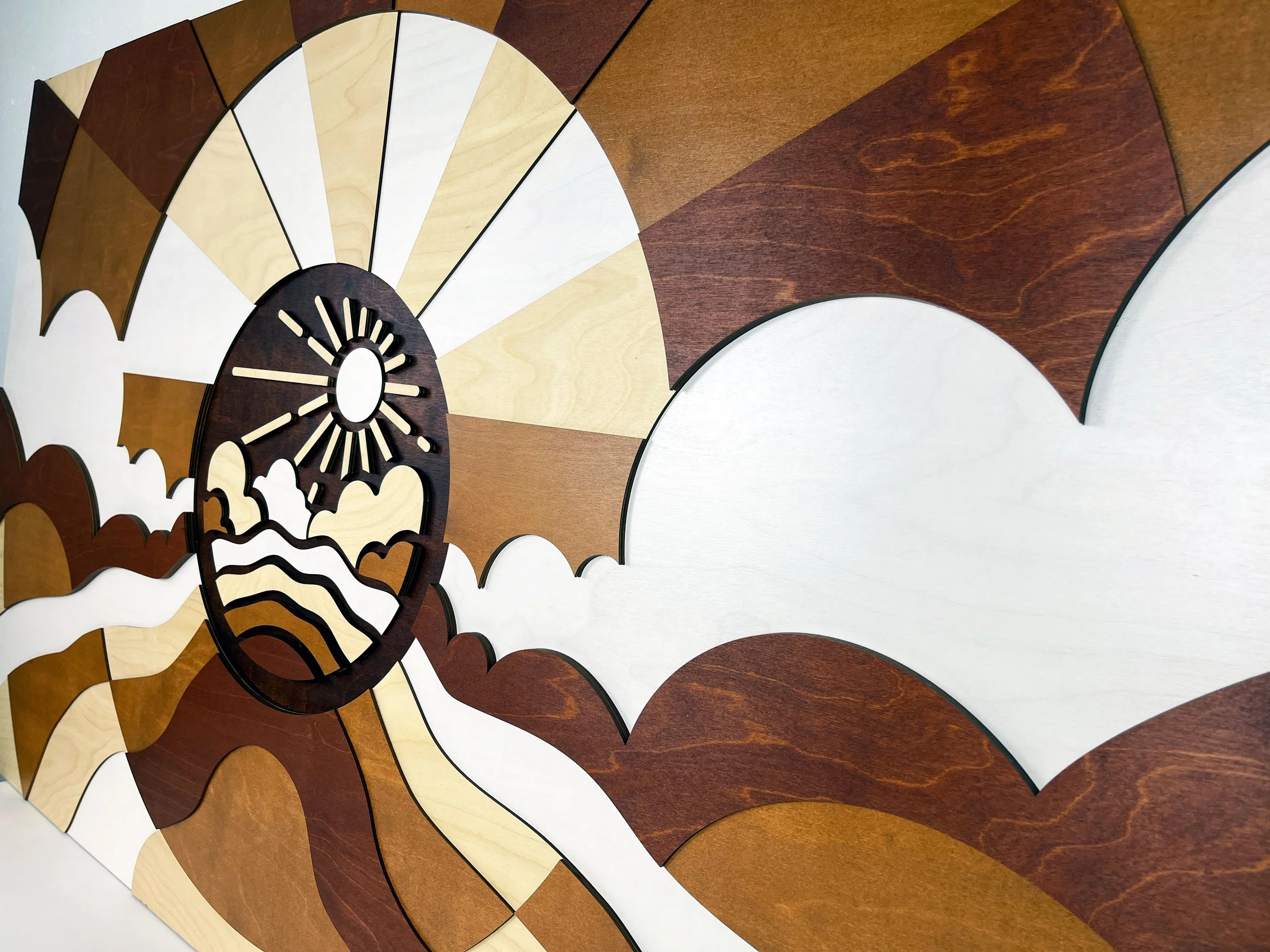 Custom wooden wall art display for PAE Engineers in Portland, OR. Made from stained baltic birch plywood and laser cut to shape.  Multi-layered sign and art piece. custom laser cutting and fabrication by MC Laser Labs.