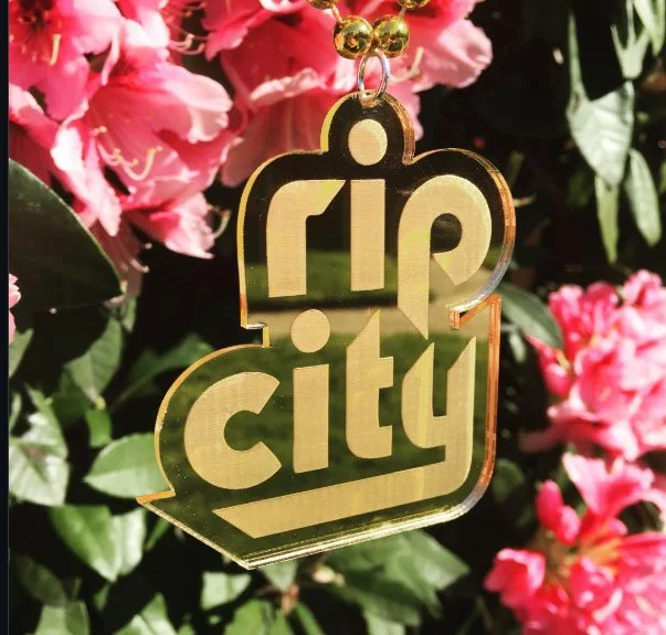 CO2 laser cut gold mirrored acrylic 'Rip City' Trail Blazers keychain, custom laser cutting by MC Laser Labs.