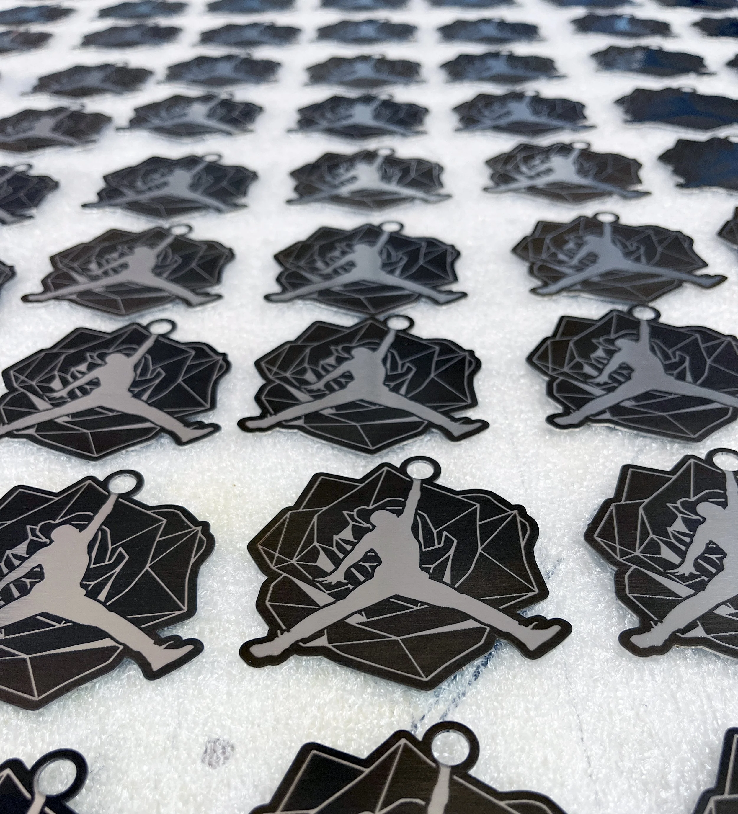 Fiber laser marked stainless steel Air Jordan keychains for a Nike Jordan event, custom metal engraving by MC Laser Labs.