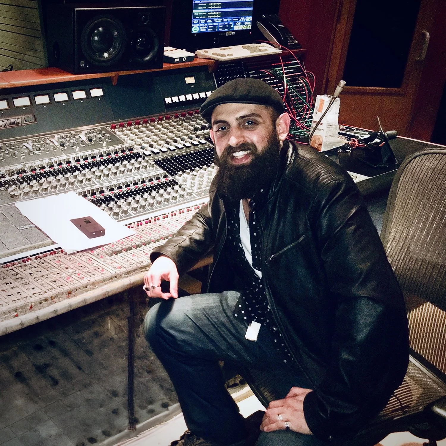 Music producer Konstantin Alexander working at a mixing console in a professional recording studio