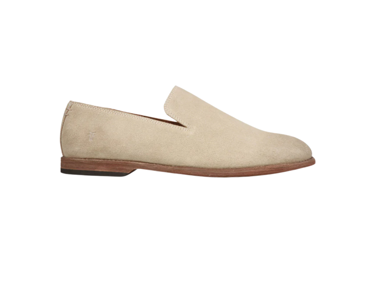 Men's beige suede slip-on shoe with a wooden sole, isolated on a white background.