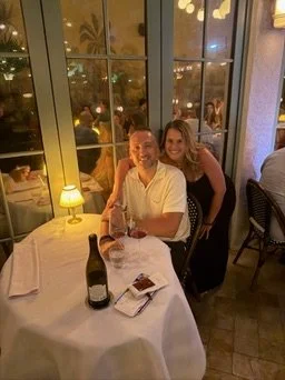 A picture of Mark & Rebecca at a dining table on the patio of Sunny's Steakhouse