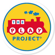 Logo of The Play Project with a red train, blue paw prints, and yellow text on a circular background