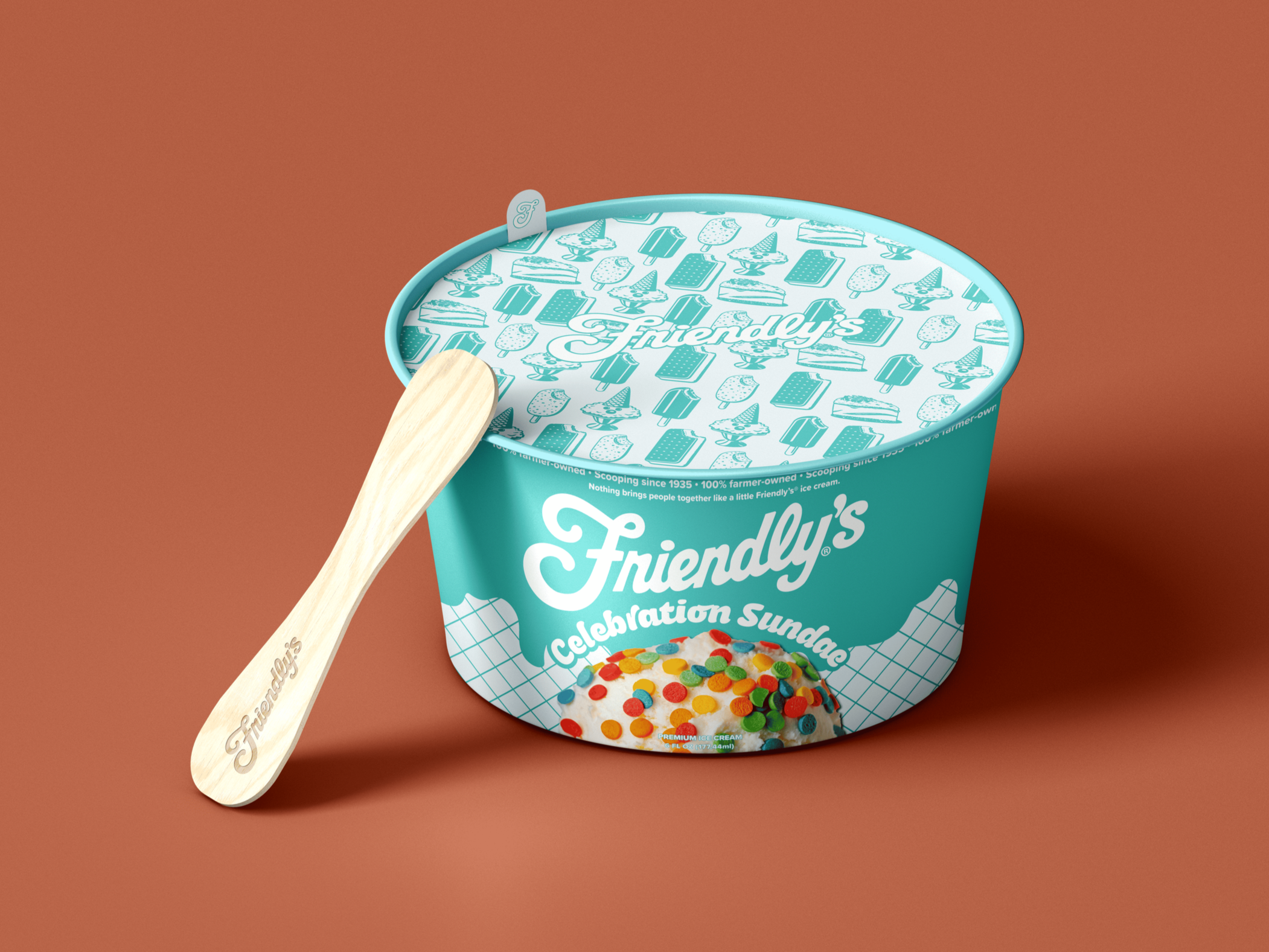 A tub of Friendly's Celebration Sunday ice cream with colorful confetti topping and a wooden spoon resting on the side of the tub.