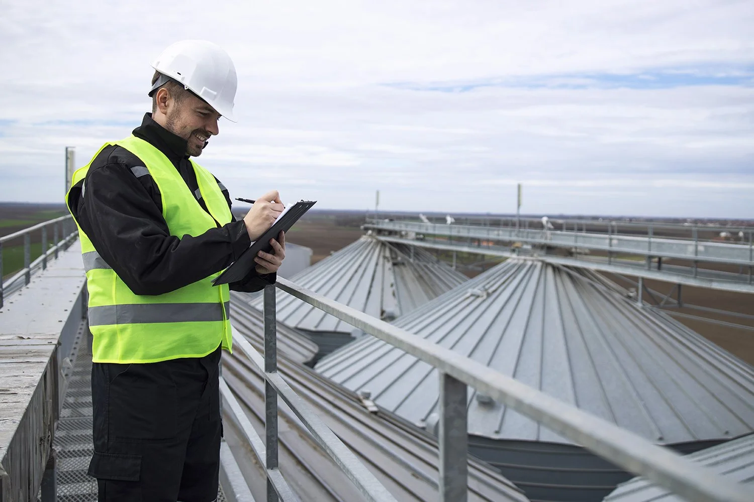 Think-Resilience-portrait-construction-worker-standing-rooftops-high-silos-storage-tanks-working-tablet-computer.jpg