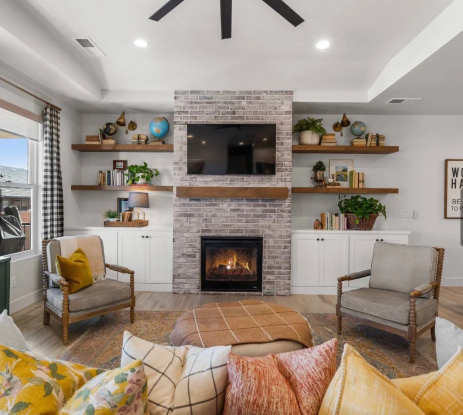 Living room with brick fireplace and custom built-in shelving, interior design by Tausha Hoyt Design in Beaufort, South Carolina